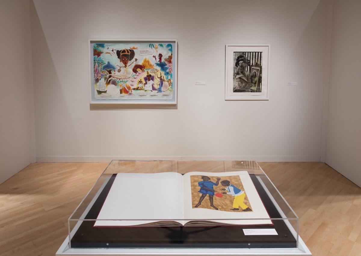 Installation view of framed works and vitrine