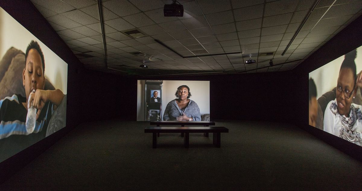 Installation view of three large scale monitors