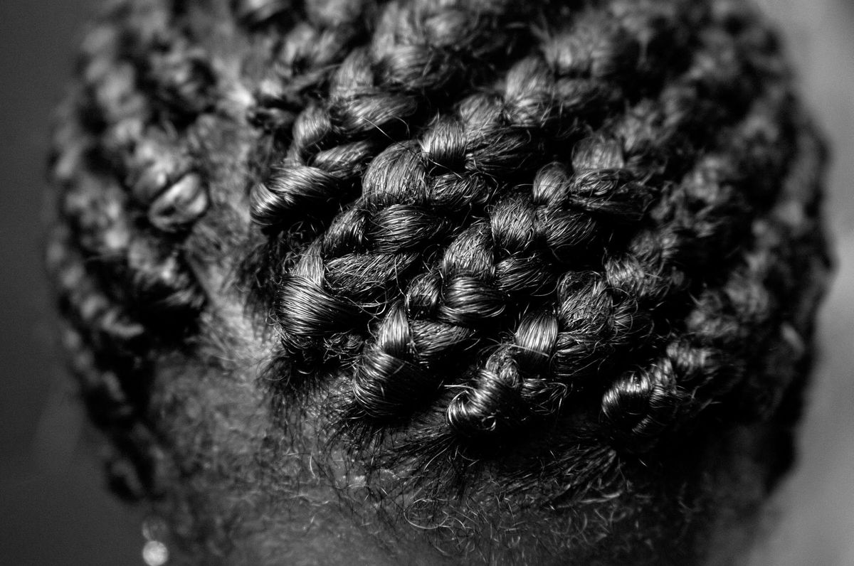 Close up portrait of a woman's finely done, thick cornrows