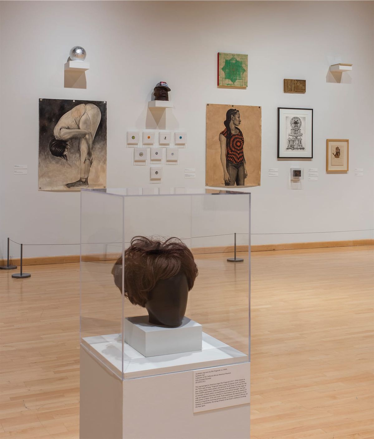 Installation view of sculpture, and large and small paintings