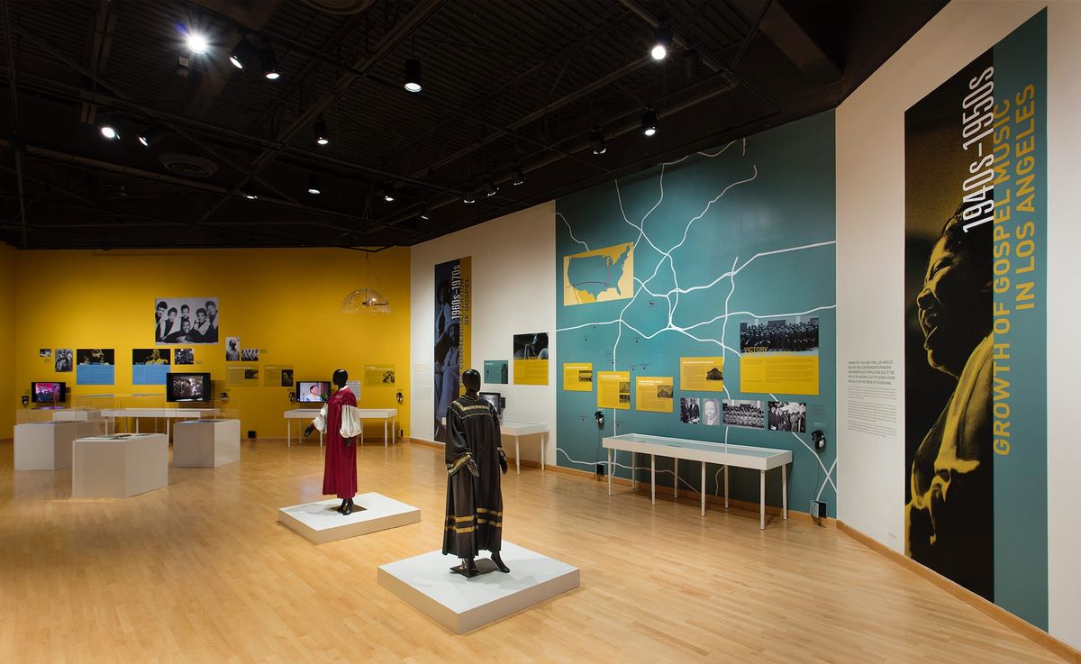 Installation view of gallery space with large scale images of gospel singers and supporting garments