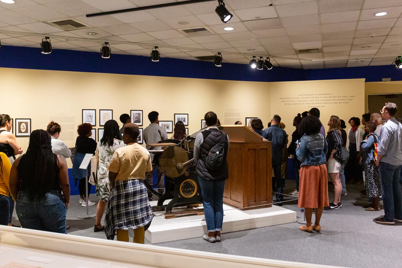 Tour group gathered around letter press and movable type
