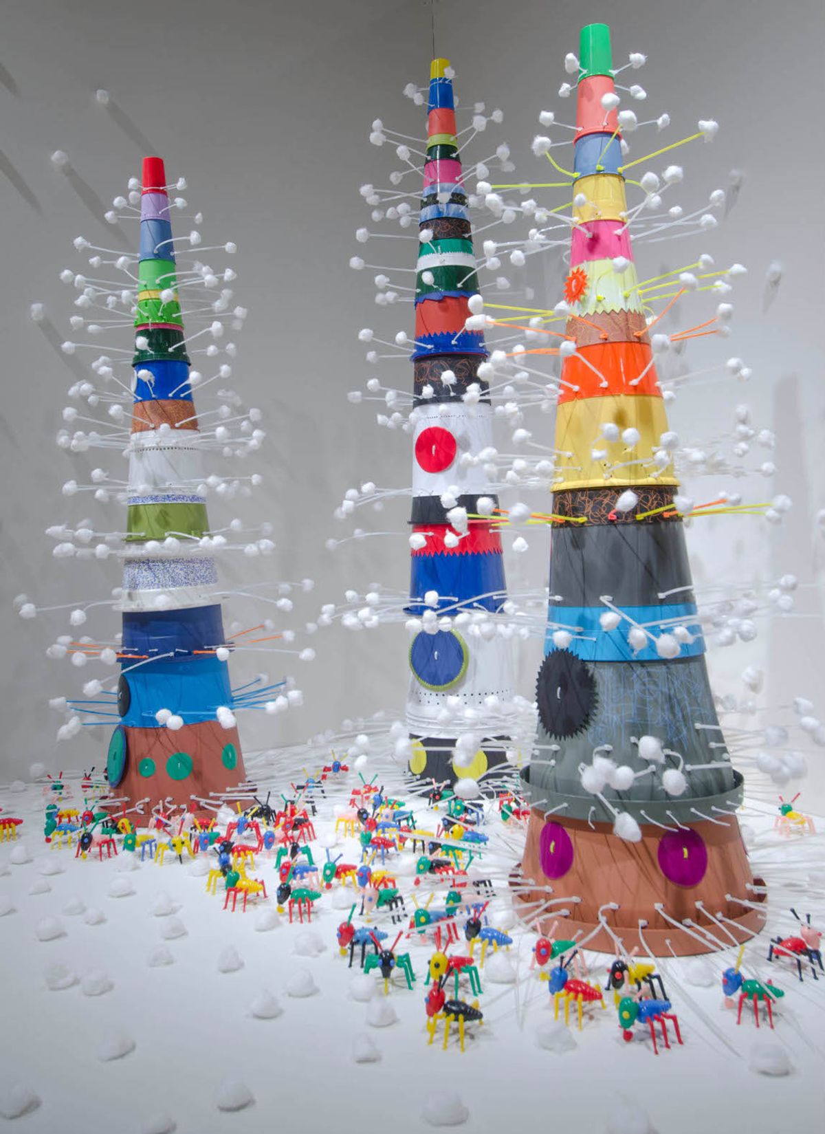 Resin and plastic assemblages that conjur ancient towers over a populated city