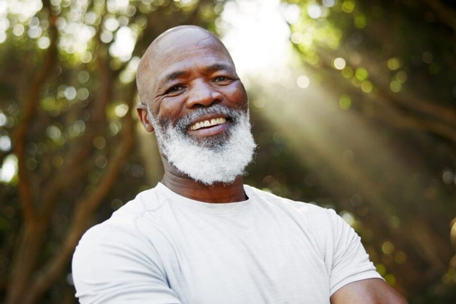 Smile, fitness and portrait of black man in nature for runner, confidence and health. Retirement, exercise pride and wellness with senior person outdoor for mobility training, athlete and hobby