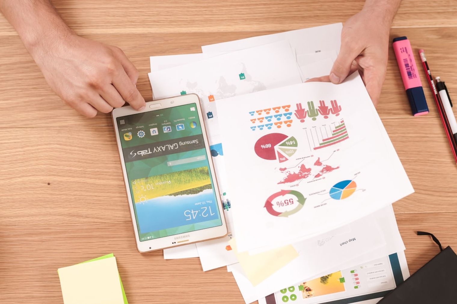 A desk covered in scattered reports and charts representing business chaos