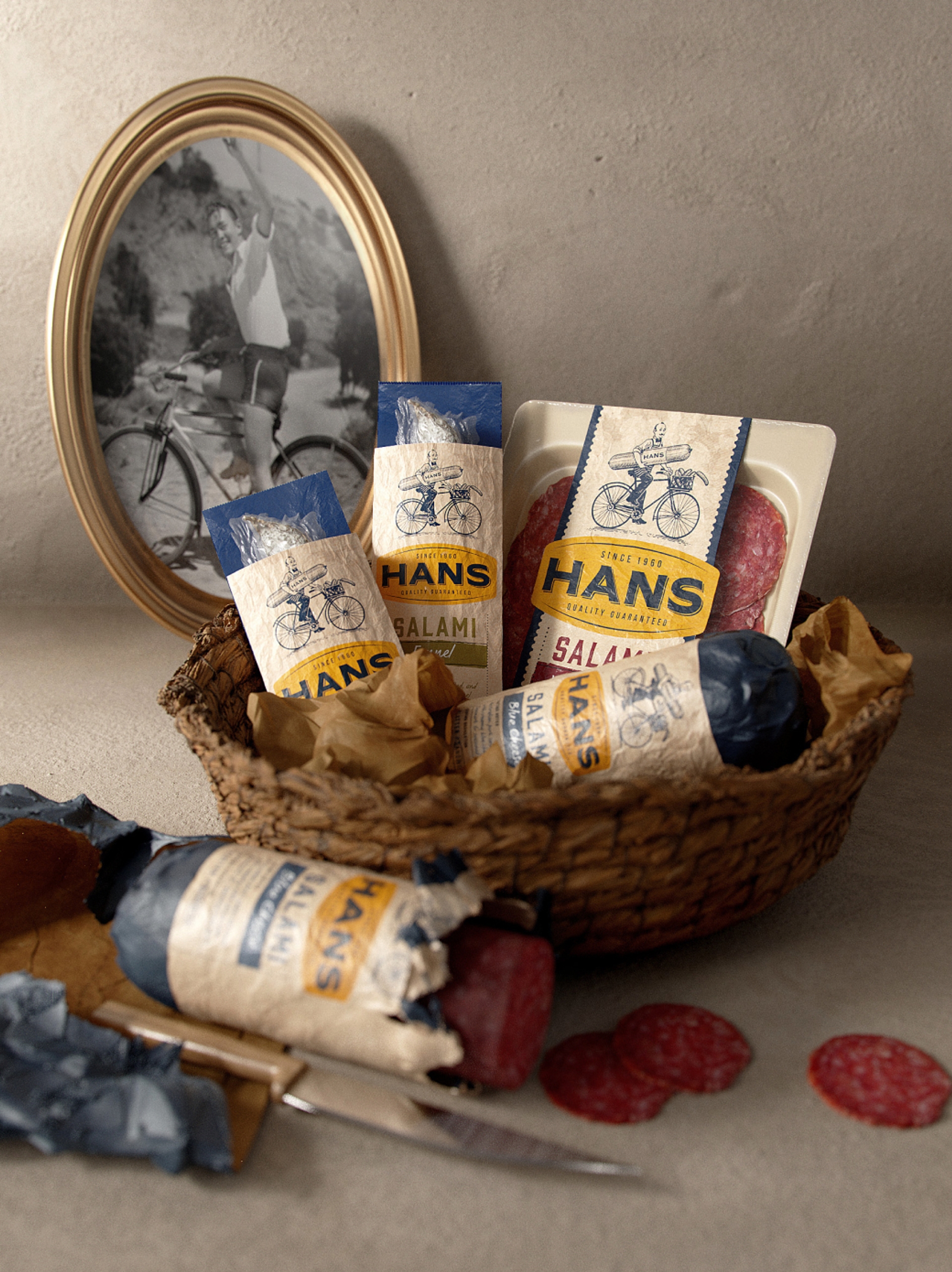 Basket of Hans packaging design meat products by branding agency Our Revolution in Sydney, in front of a framed black and white portrait of a man on a bicycle