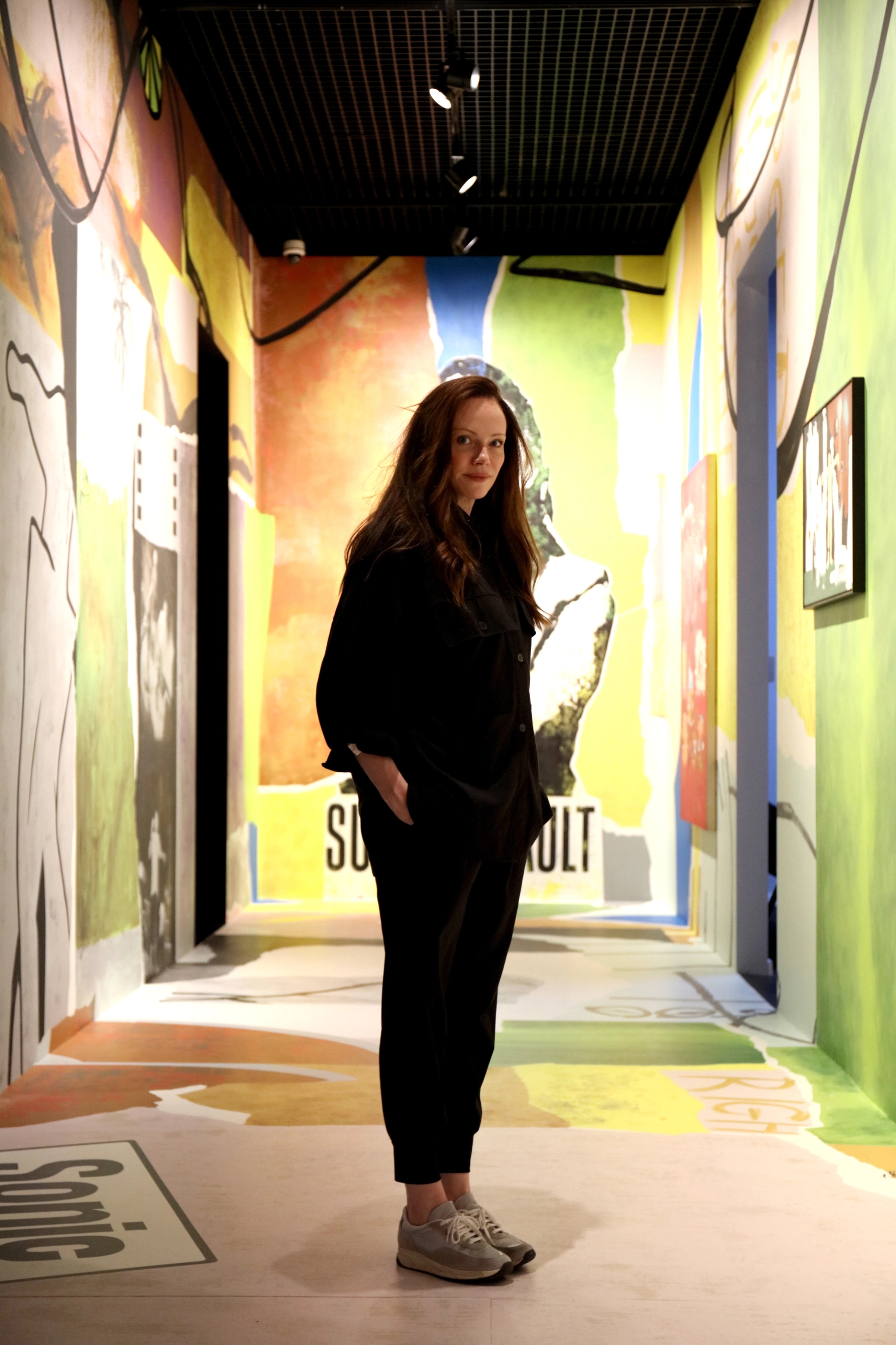 Creative Director Jen Doran Founder of global brand design agency Our Revolution standing in corridor