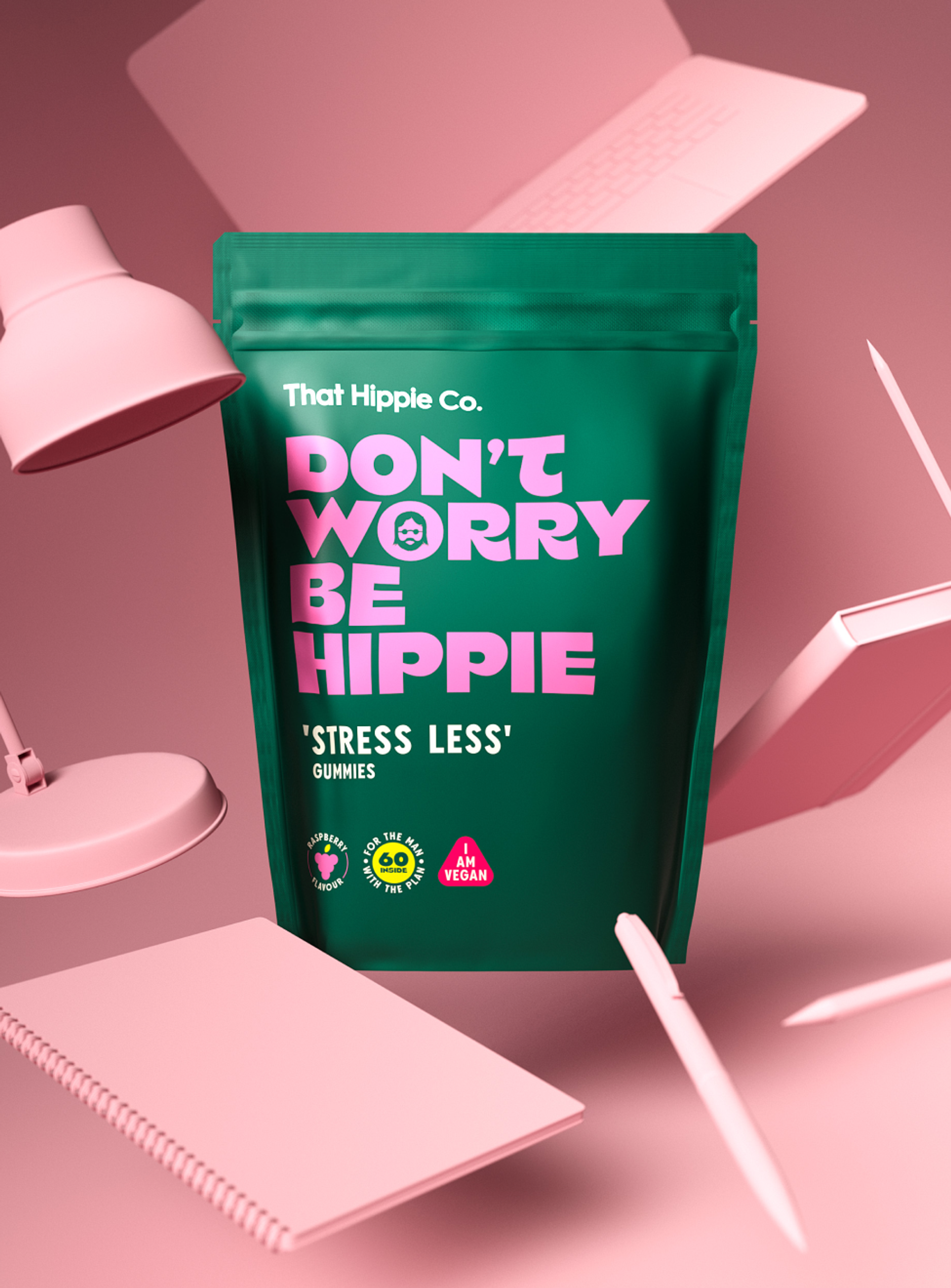 Gummies packaging design by branding agency in Australia Our Revolution for That Hippie Co supplement brand with pastel pink office accessories for vegan “Stress Less” gummies featuring brand slogan “Don’t worry be hippie”.