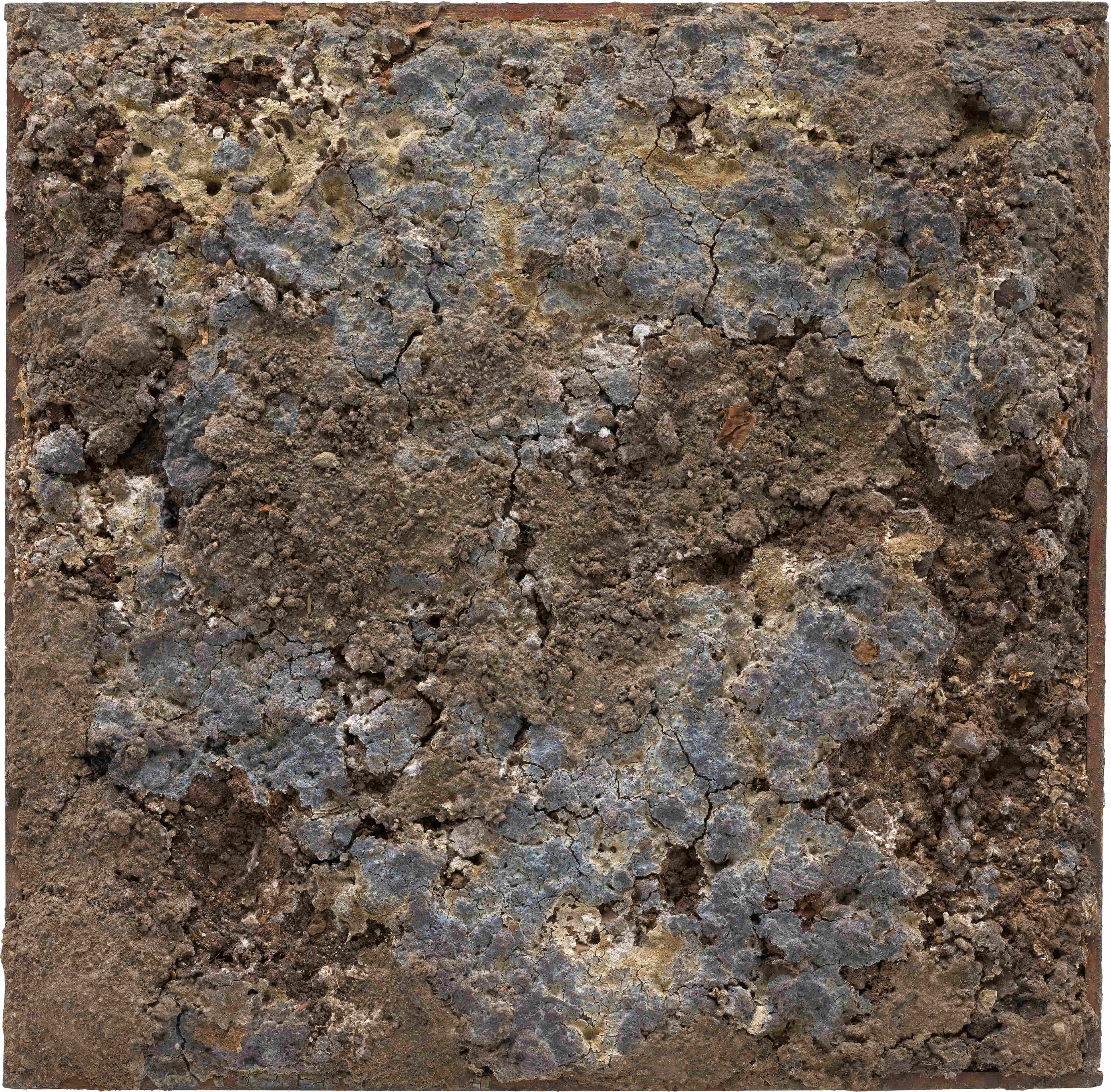 A textured, abstract artwork featuring a square panel with a rough surface. The panel displays a mix of earthy tones, including grays, browns, and hints of blue, resembling a weathered or eroded material. The background is plain white, emphasizing the panel's rugged texture and organic patterns.