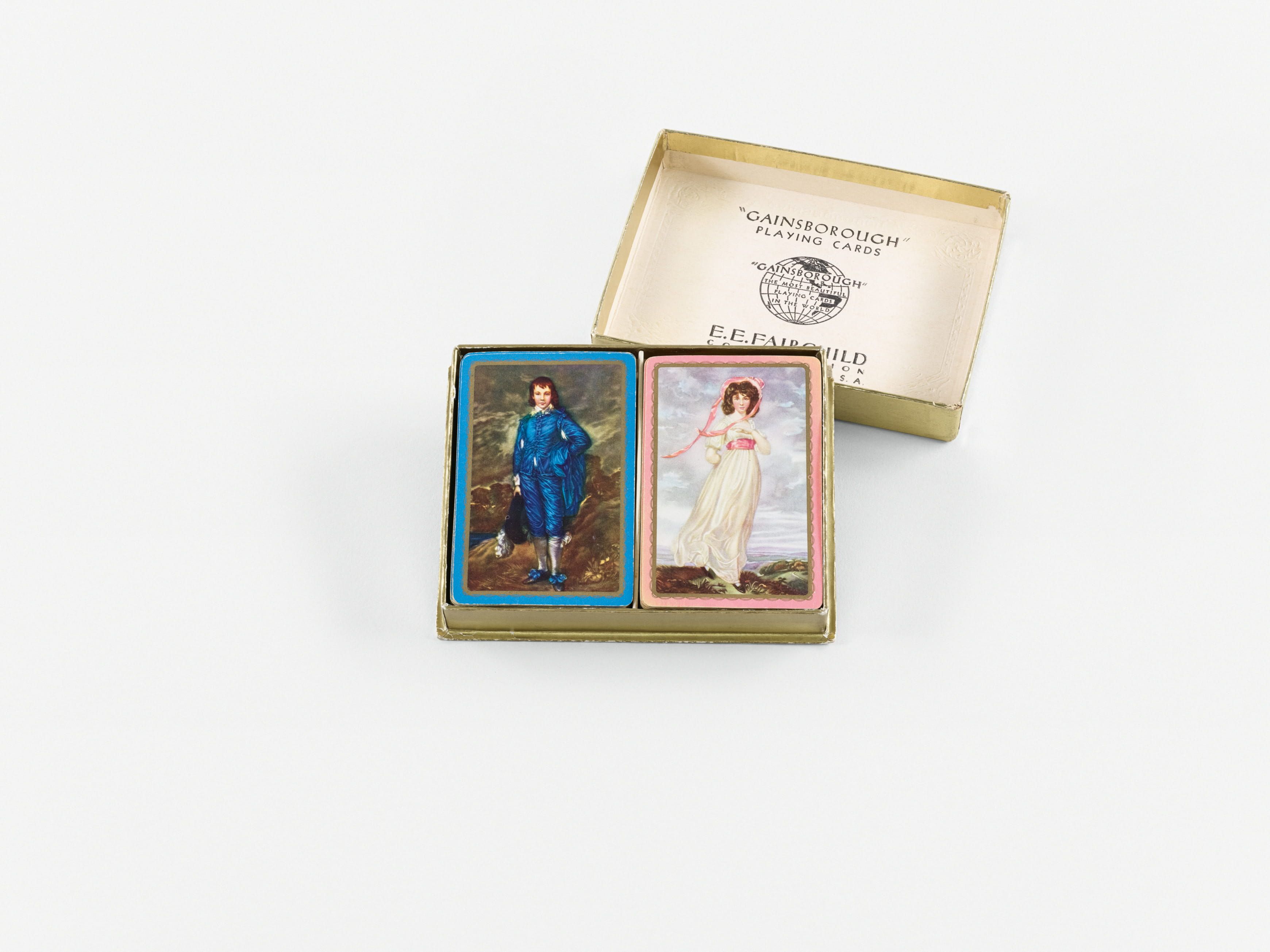 A set of "Gainsborough" playing cards is displayed, featuring two decks with artistic portraits on the back, one of a man in blue attire and the other of a woman in a white dress, inside an open box.
