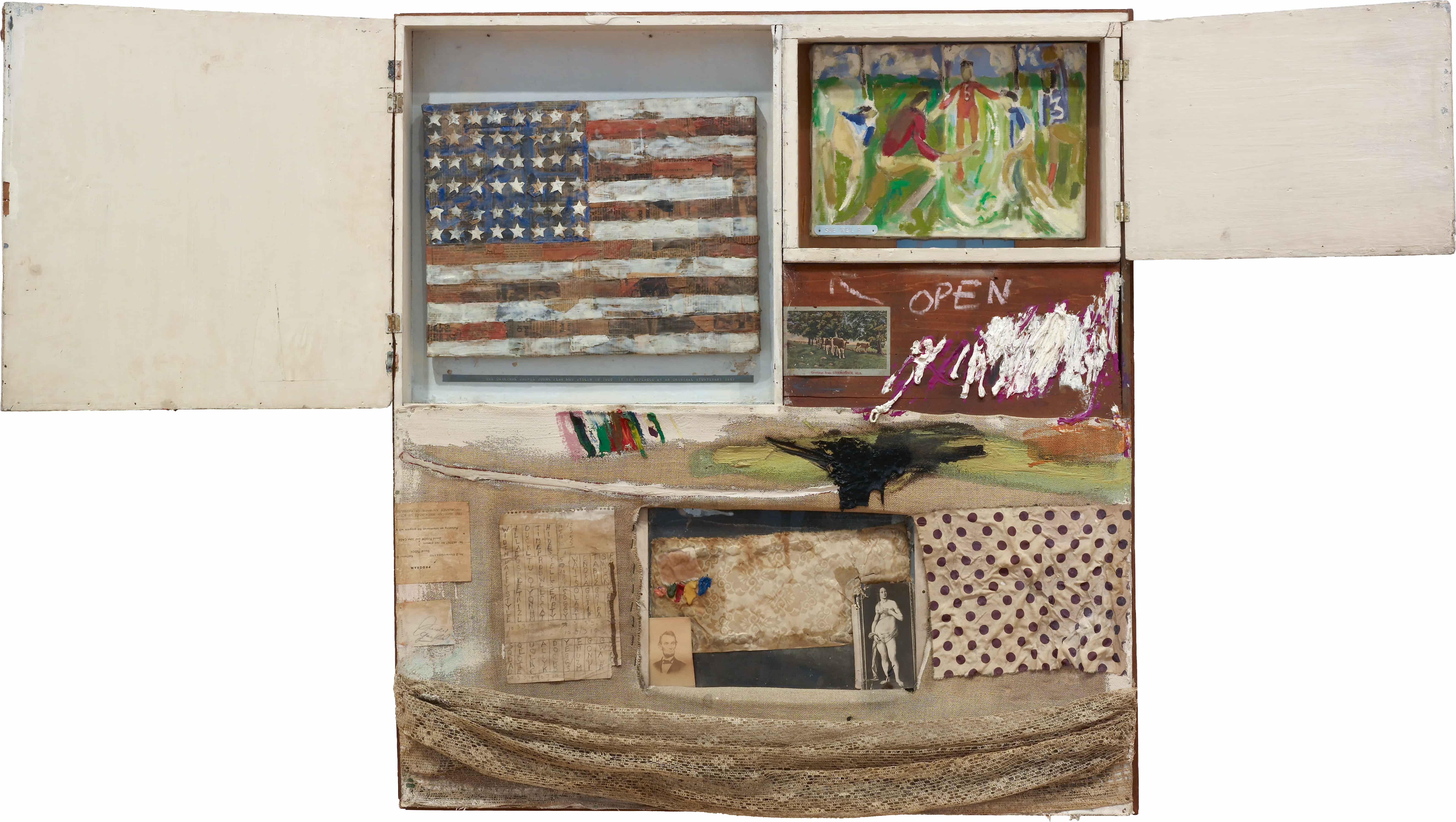 An open wooden cabinet displays a fragmented American flag, a painted scene of riders, and various collaged elements, including a portrait and a handwritten "OPEN" sign.