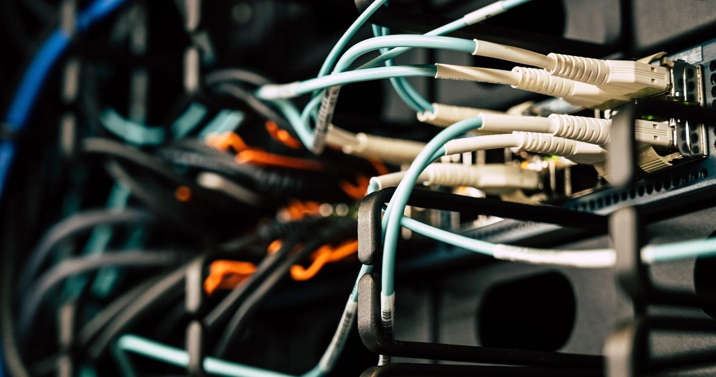 Ethernet ports and connected cables in a server rack.