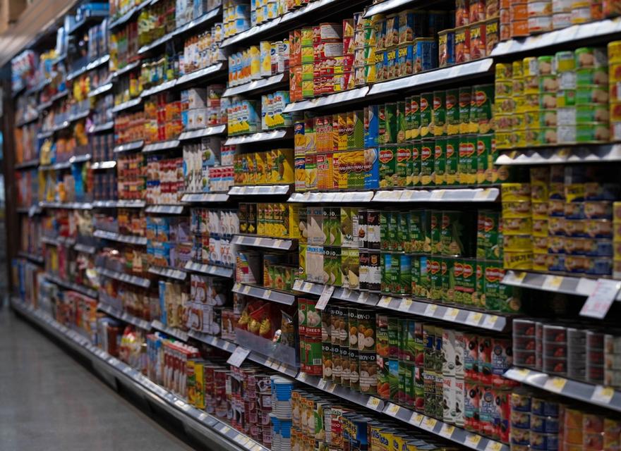 Packaged products arranged on supermarket shelves.