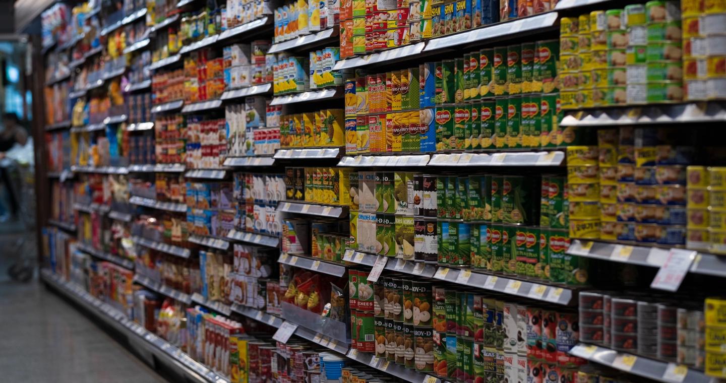 Packaged products arranged on supermarket shelves.