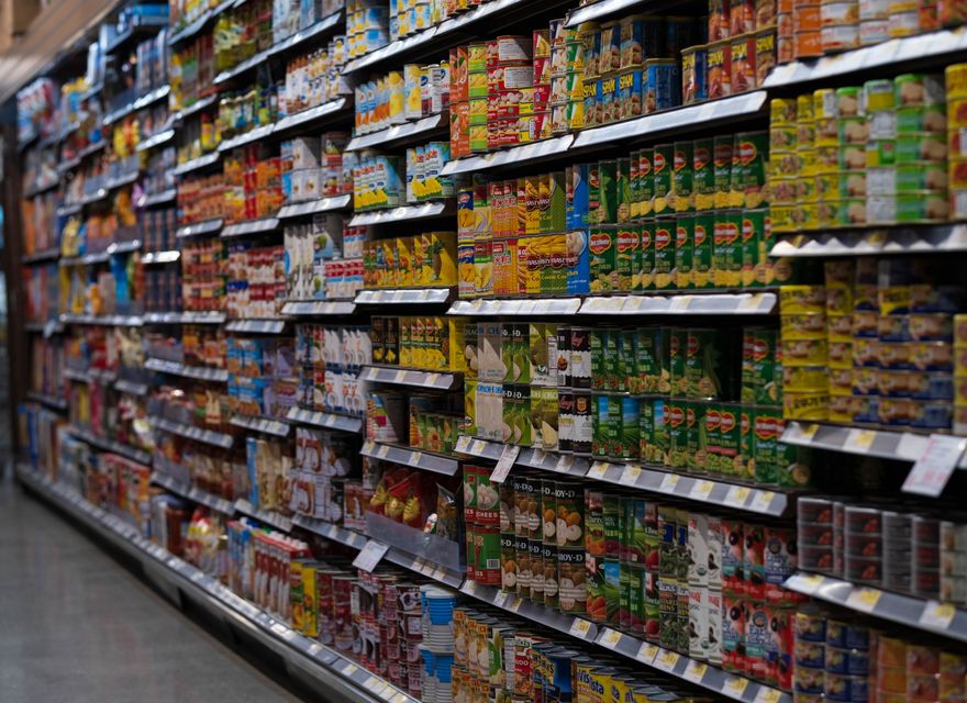 Packaged products arranged on supermarket shelves.
