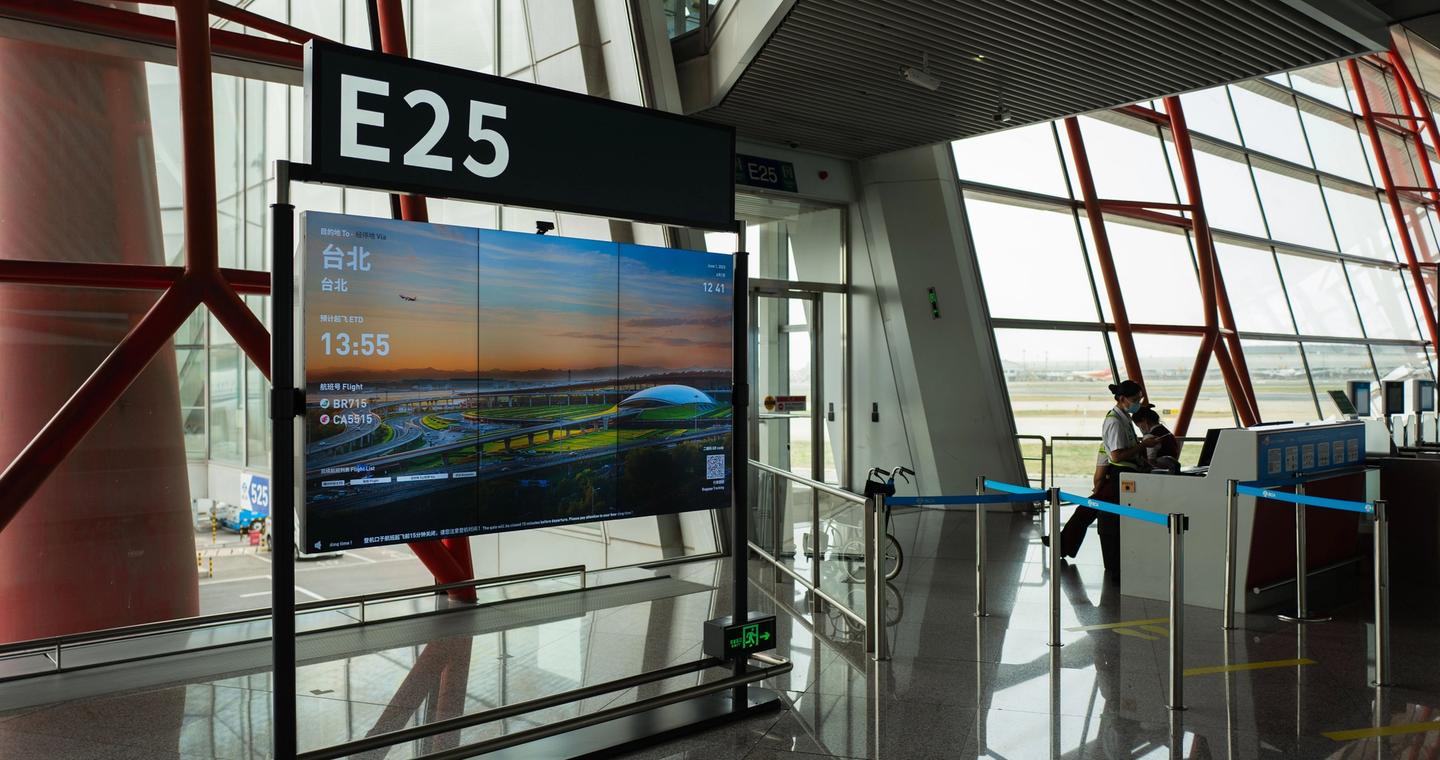 Airport gate E25 with a digital display.