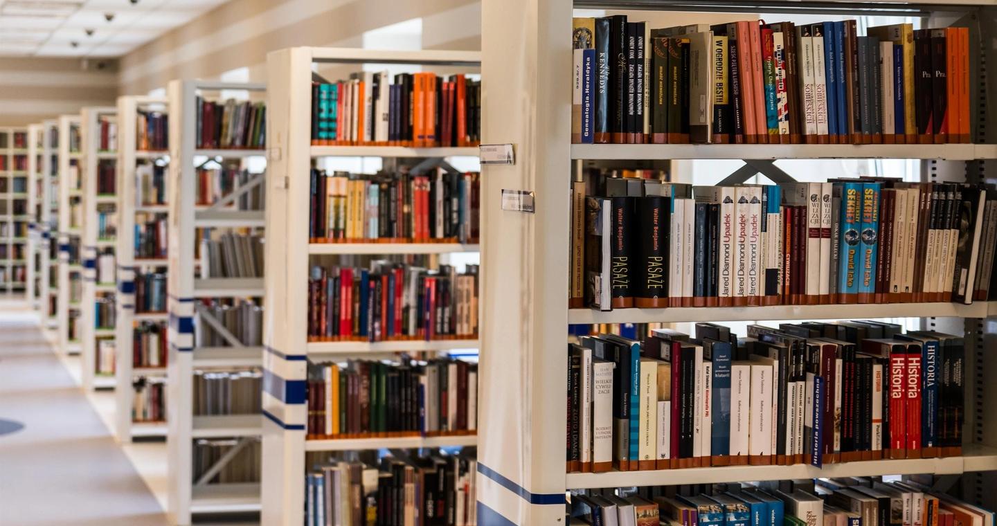 Rows of books arranged on library shelves.