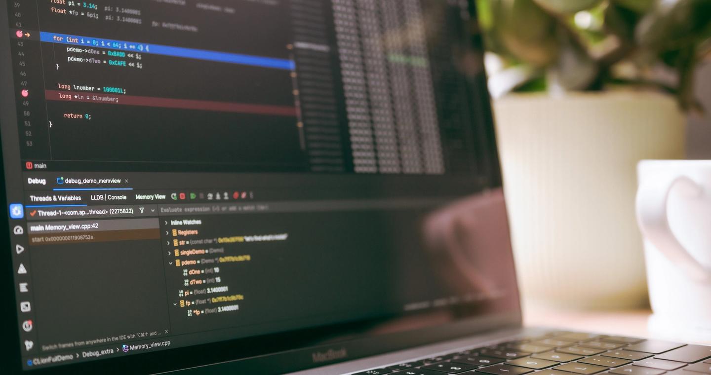 A laptop screen showing code and debugging tools.