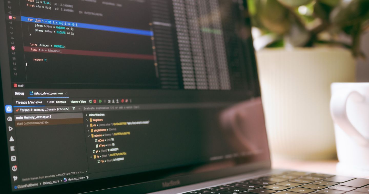 A laptop screen showing code and debugging tools.