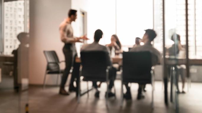 Blurred image of people at a boardroom table