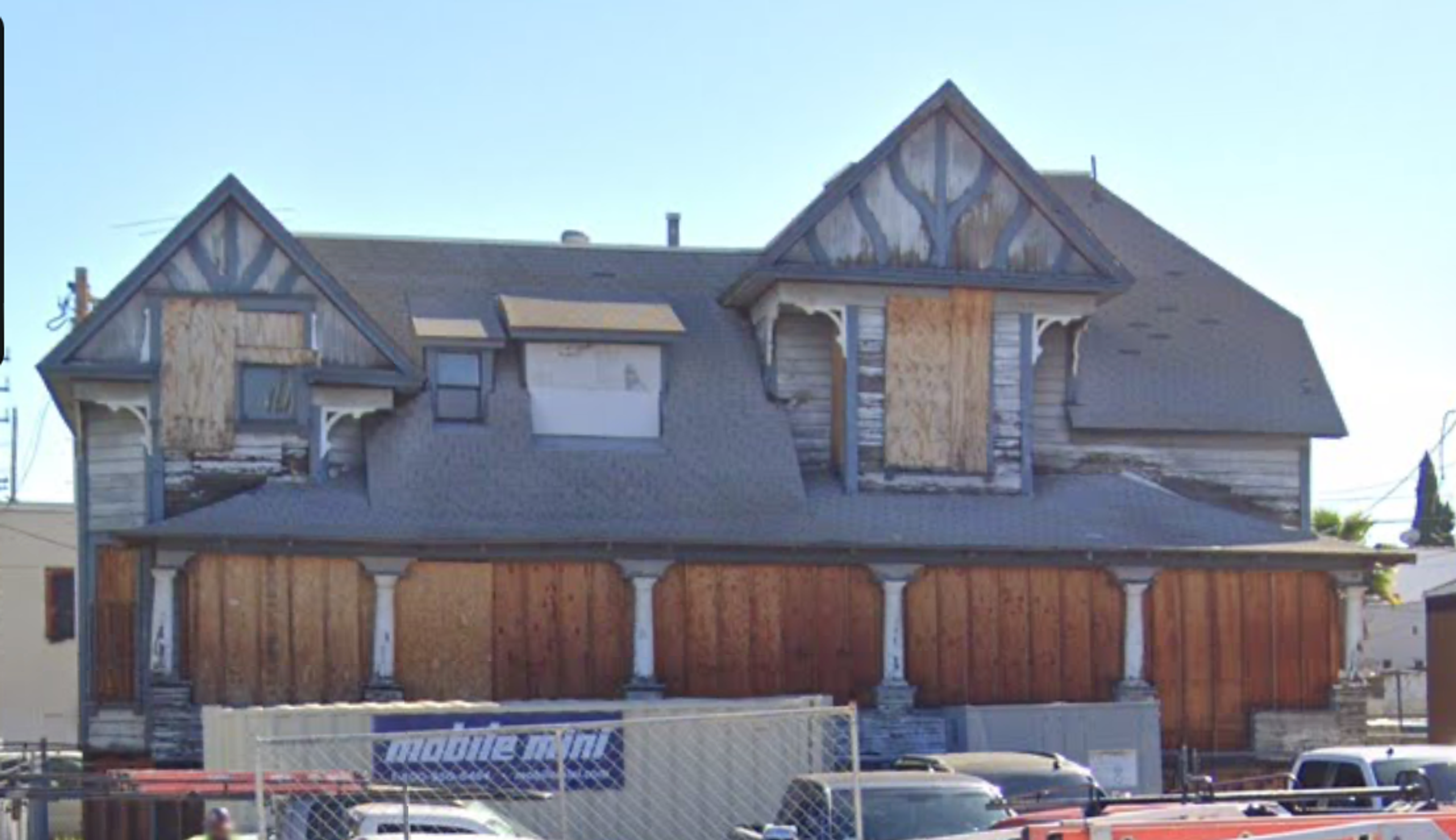 Street view of the boarded-up 1895 Peabody Werden house.