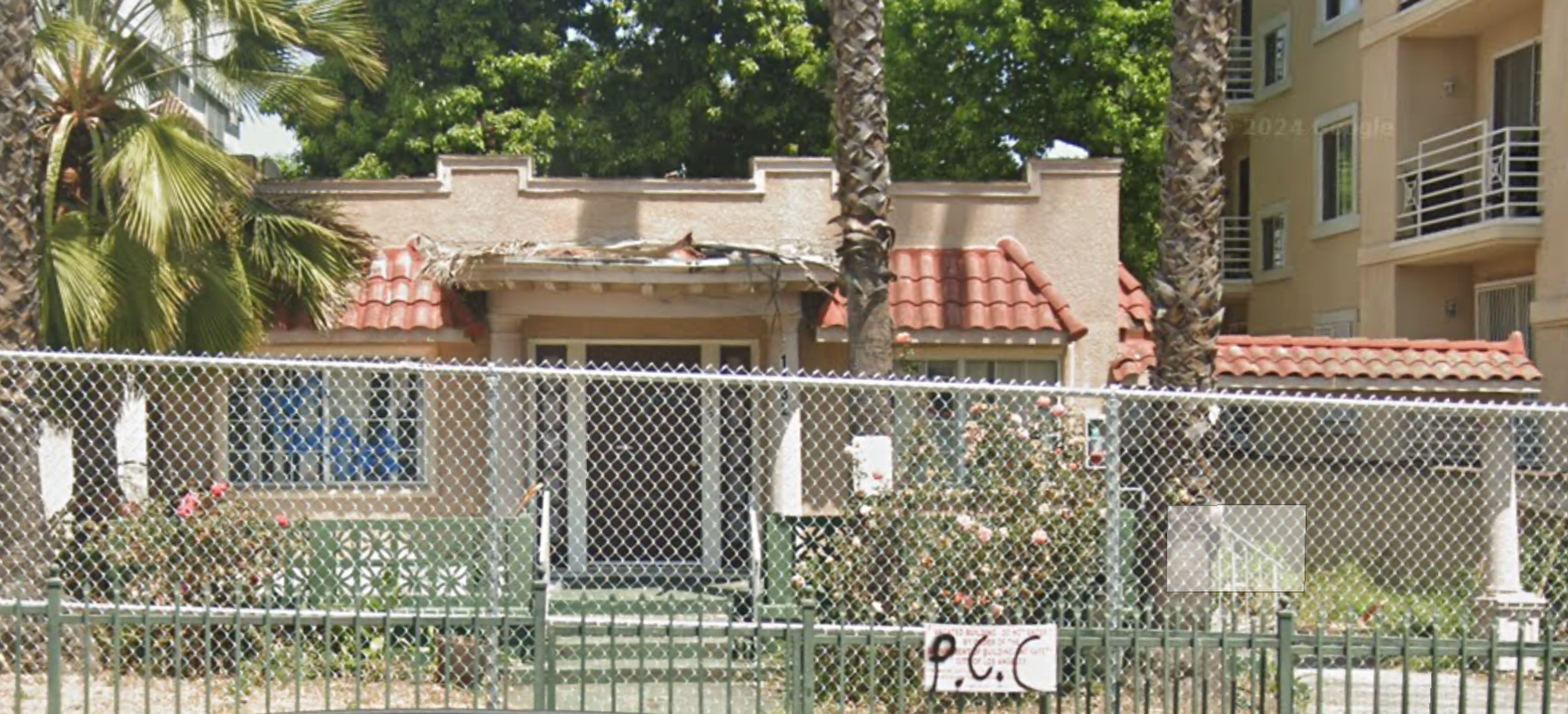 1432 N. Detroit Street, a Spanish-style bungalow, fenced off from the street.