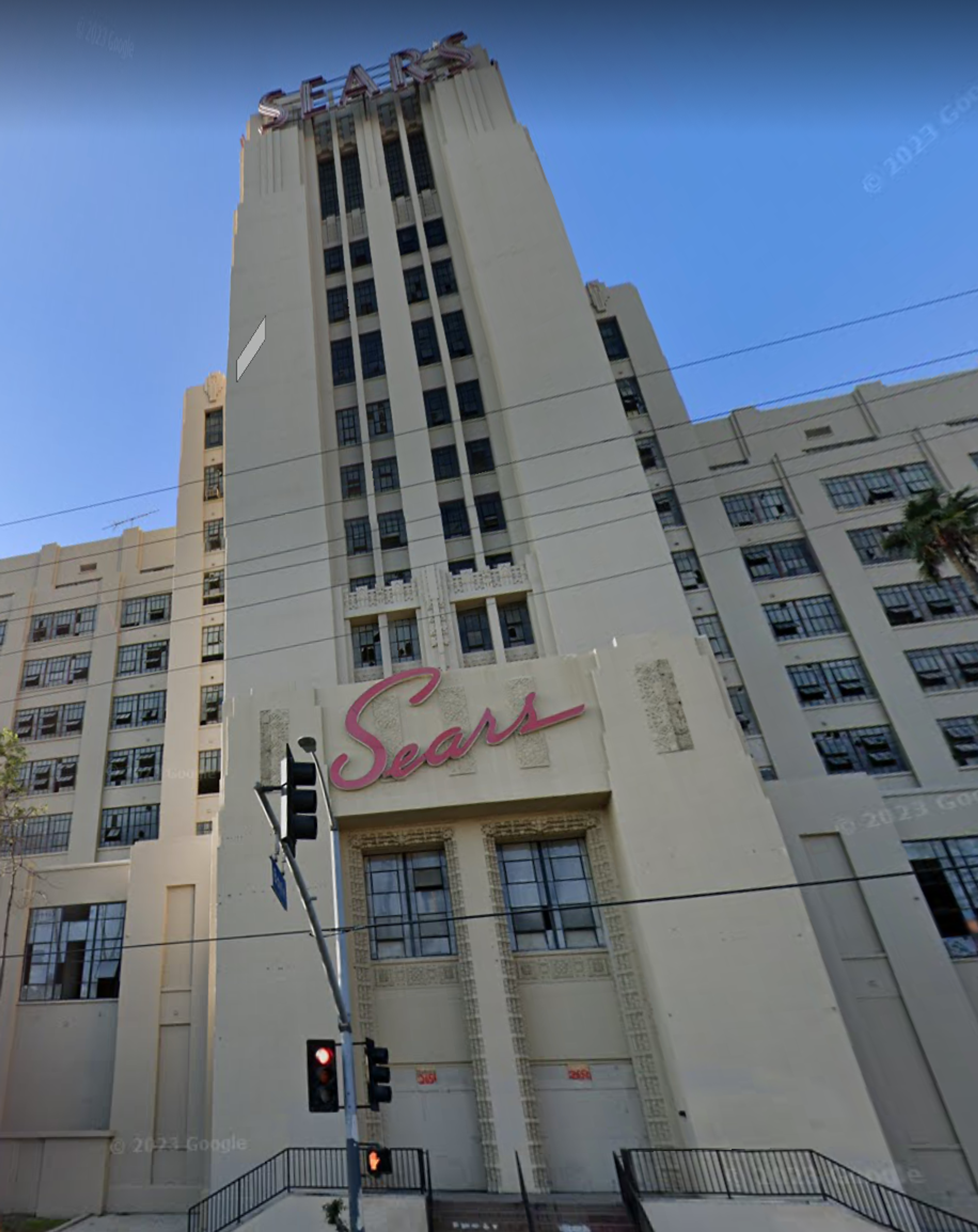 Image of the closed Boyle Heights Sears store, a Streamline building with a tower and neon signs.