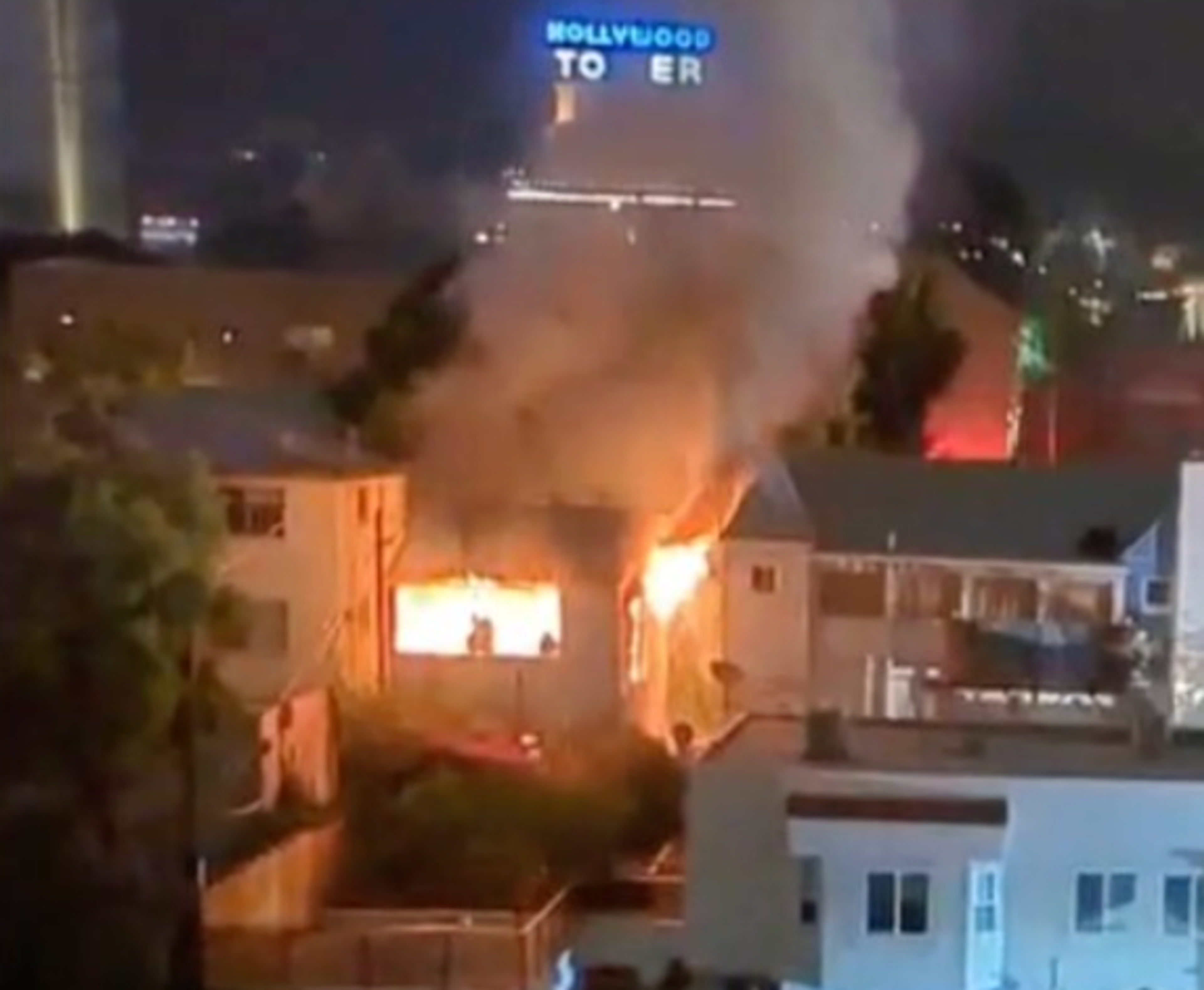 Screenshot of 1765 Vista del Mar Avenue in Hollywood burning down around 1:30 am on June 8, 2024. The Hollywood Tower's neon sign is visible in the background.