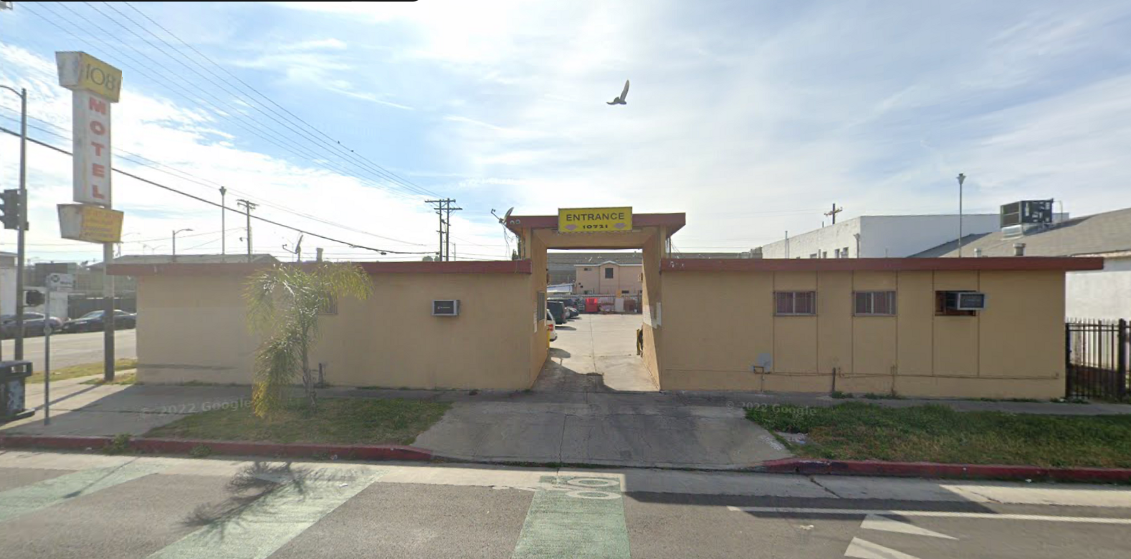 Image of the 108 Motel, a beige one-story motel in poor condition, via Google Maps.