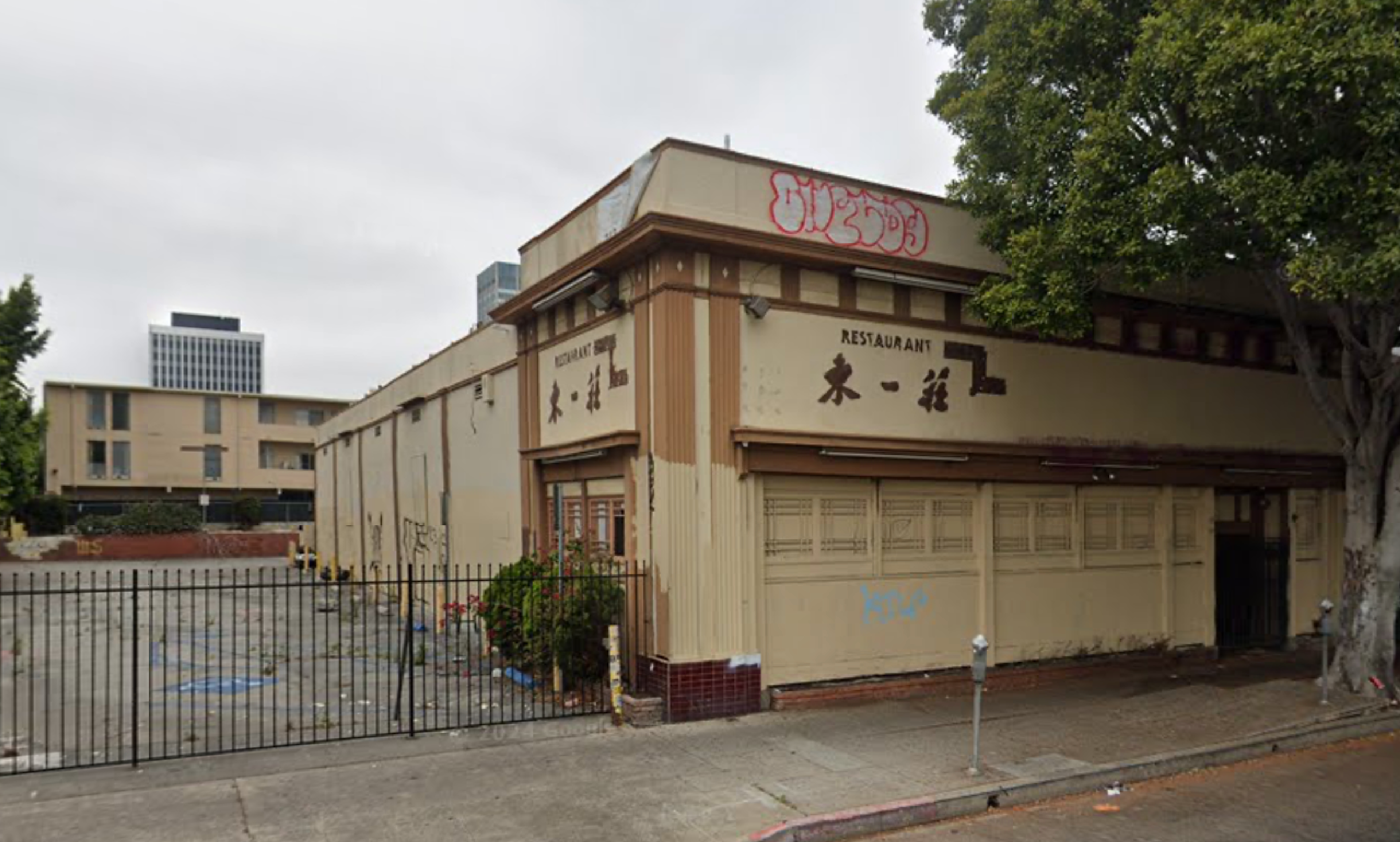 Street View of 3455 W. 8th Street, a boarded-up, defaced one-story former Korean restaurant.