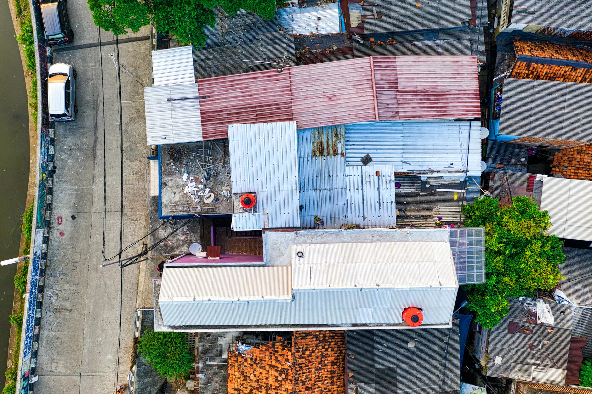Vibrant aerial shot of diverse rooftops and street in bustling urban area.
