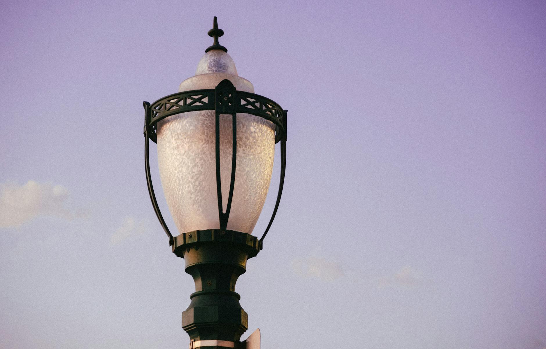 A classic street lamp set against a serene purple sky, ideal for urban design themes.