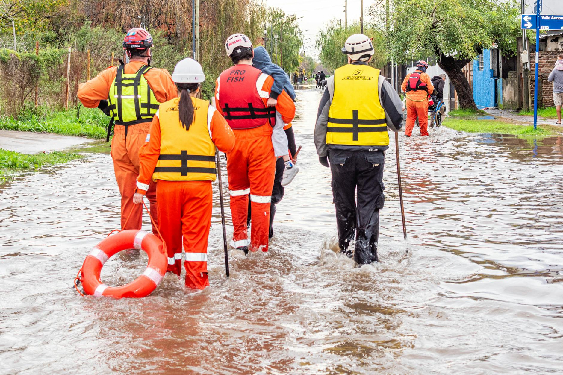 Rescue team evacuates flood victims in Buenos Aires. Humanitarian aid at work.