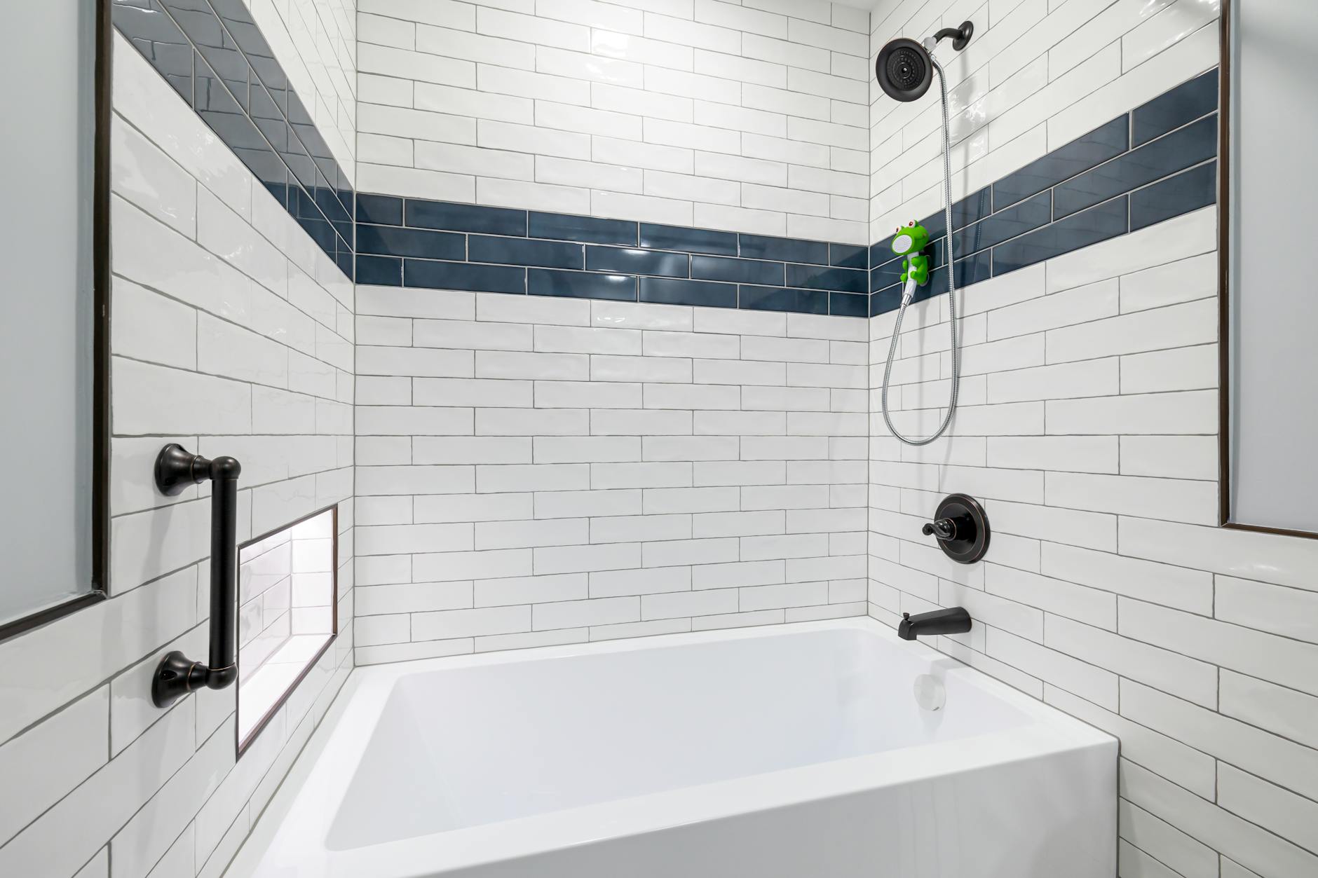Sleek, minimalist bathroom with white and blue tiles and contemporary fixtures.