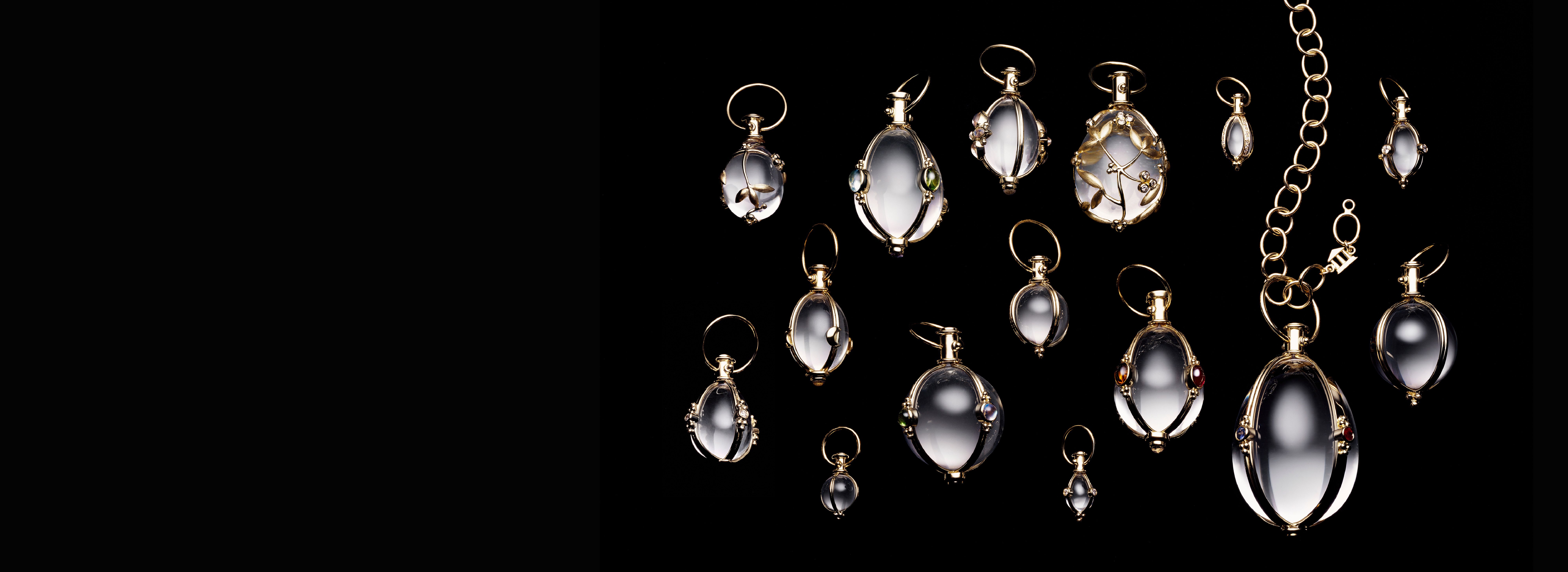 Clear, gold-trimmed pendants on a black background.