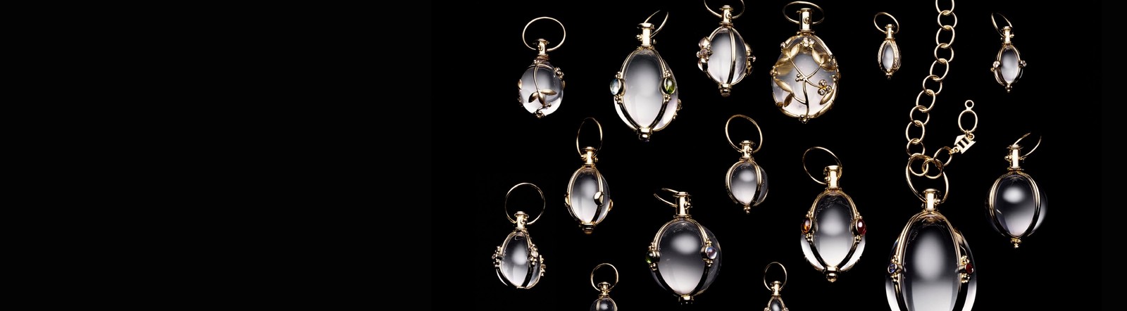 Clear, gold-trimmed pendants on a black background.