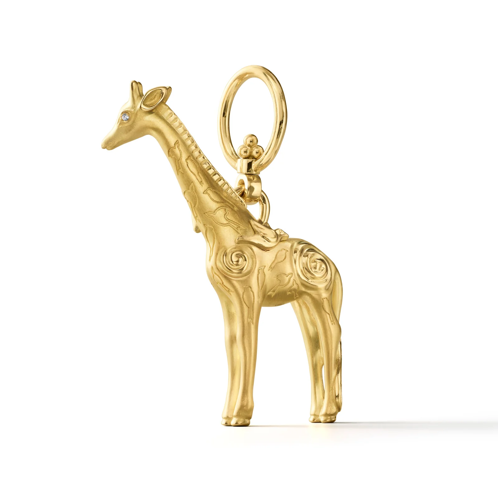Golden giraffe charm with intricate swirling patterns and a diamond eye.