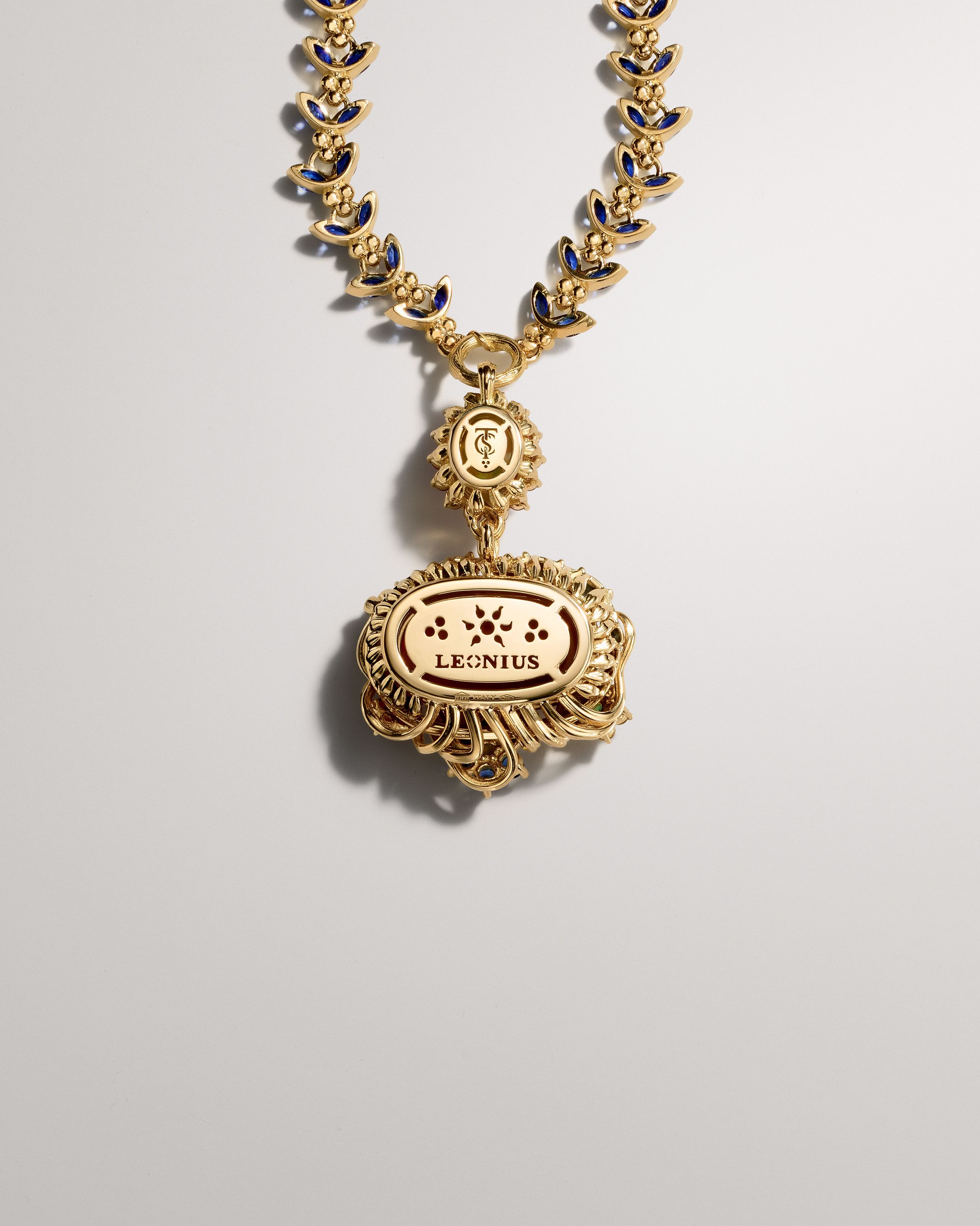 Ornate gold chain with blue enamel links and a large, oval gold pendant inscribed with 'LEONIUS'.