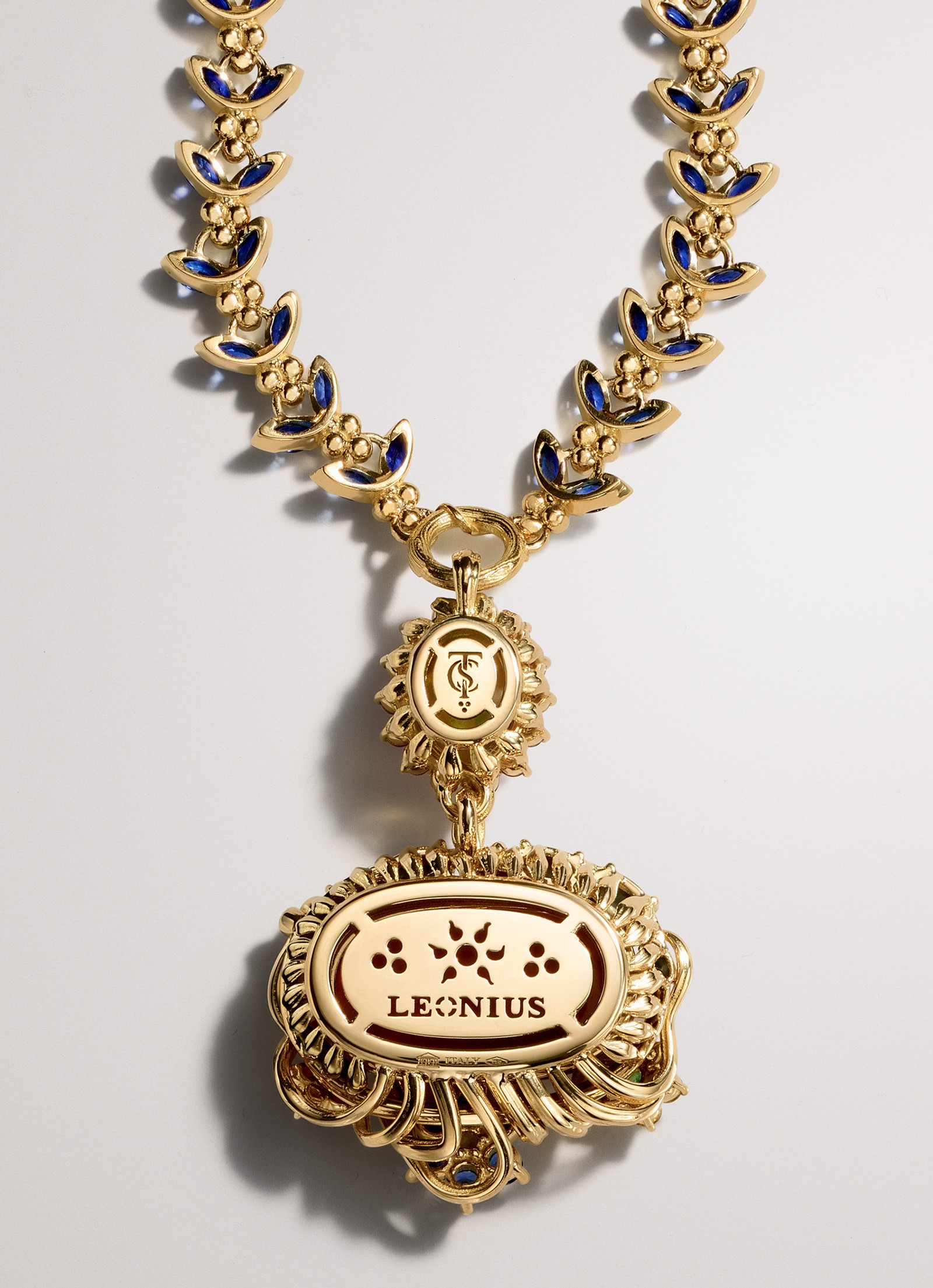 Ornate gold chain with blue enamel links and a large, oval gold pendant inscribed with 'LEONIUS'.