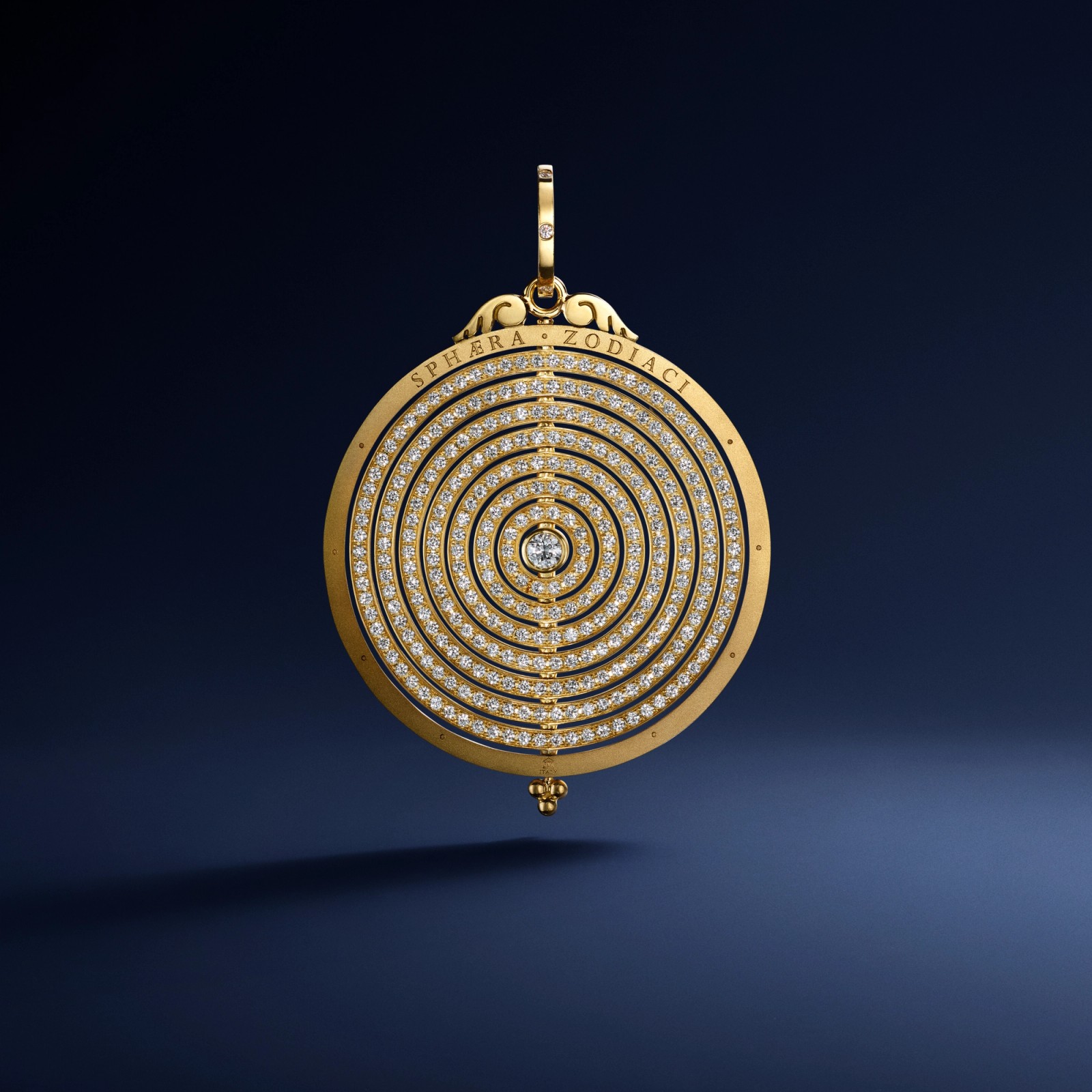 Gold circular pendant with concentric diamond rings and "SPHERA ZODIA CI" inscription.