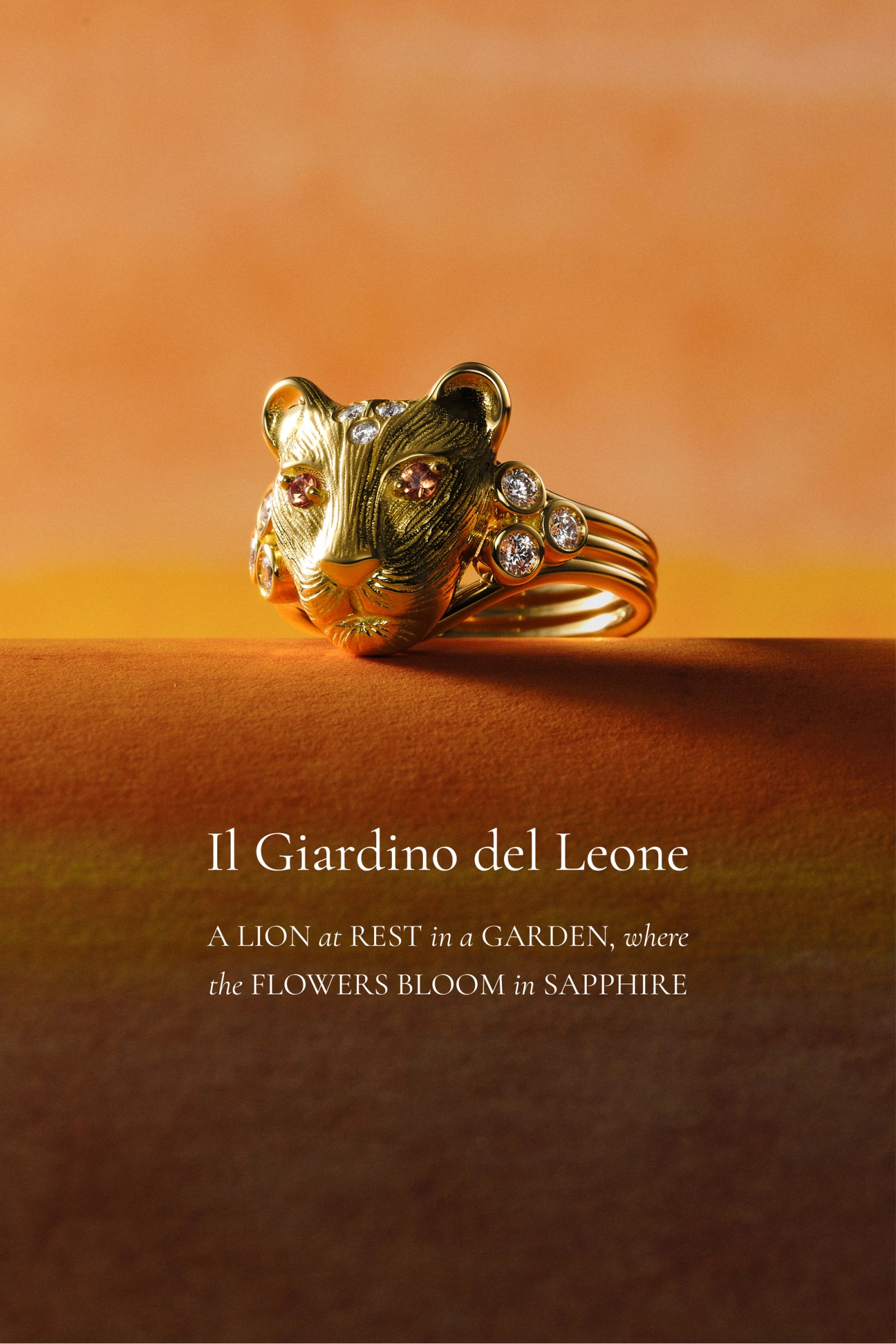 A golden panther-head ring adorned with clear and amber gemstones, sitting on a textured brown and orange surface.