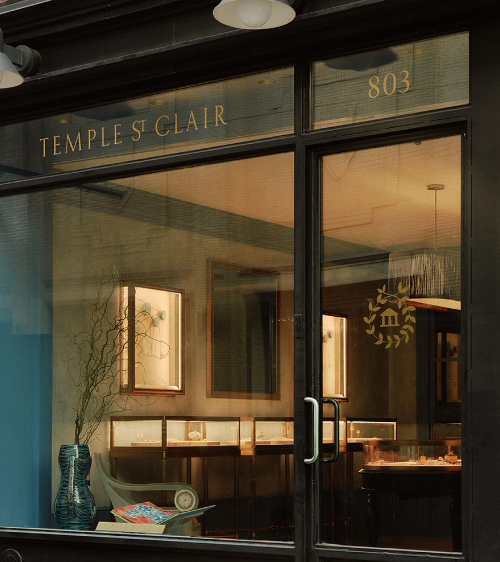 Storefront of Temple St Clair jewelry shop showing display cases and number 803.