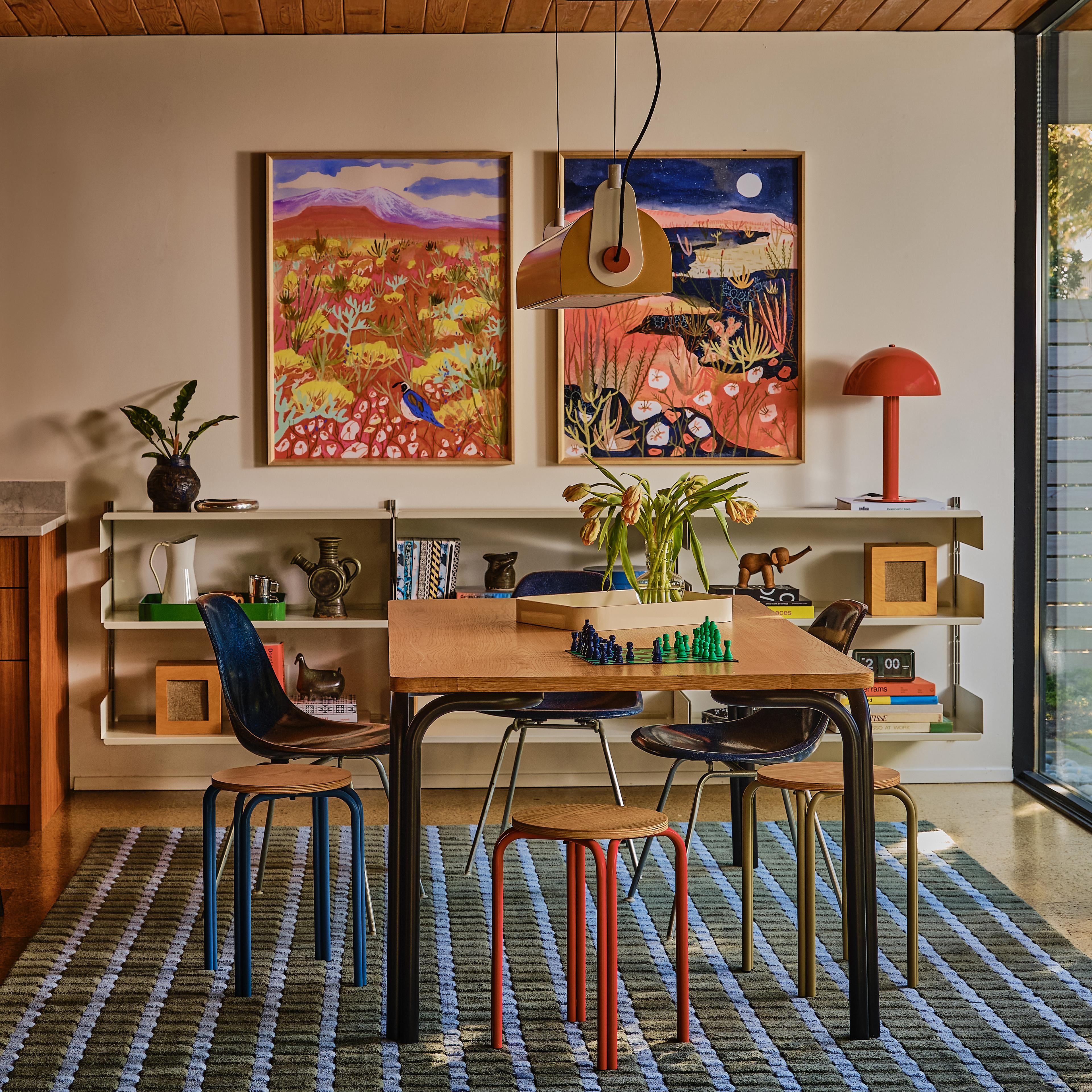 Modern dining room with yellow chandelier and colorful accents 