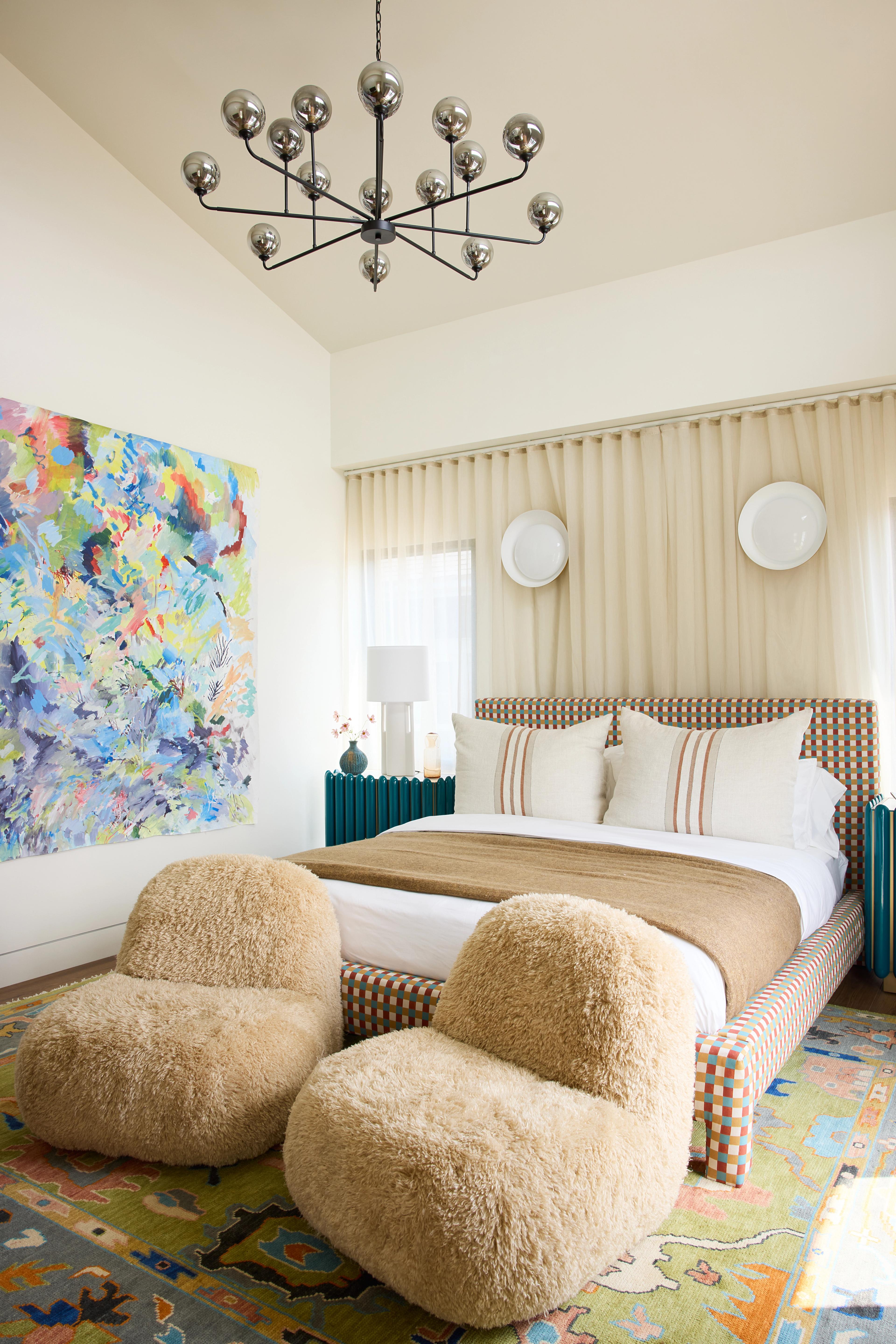 Neutral bedroom with colorful rug 