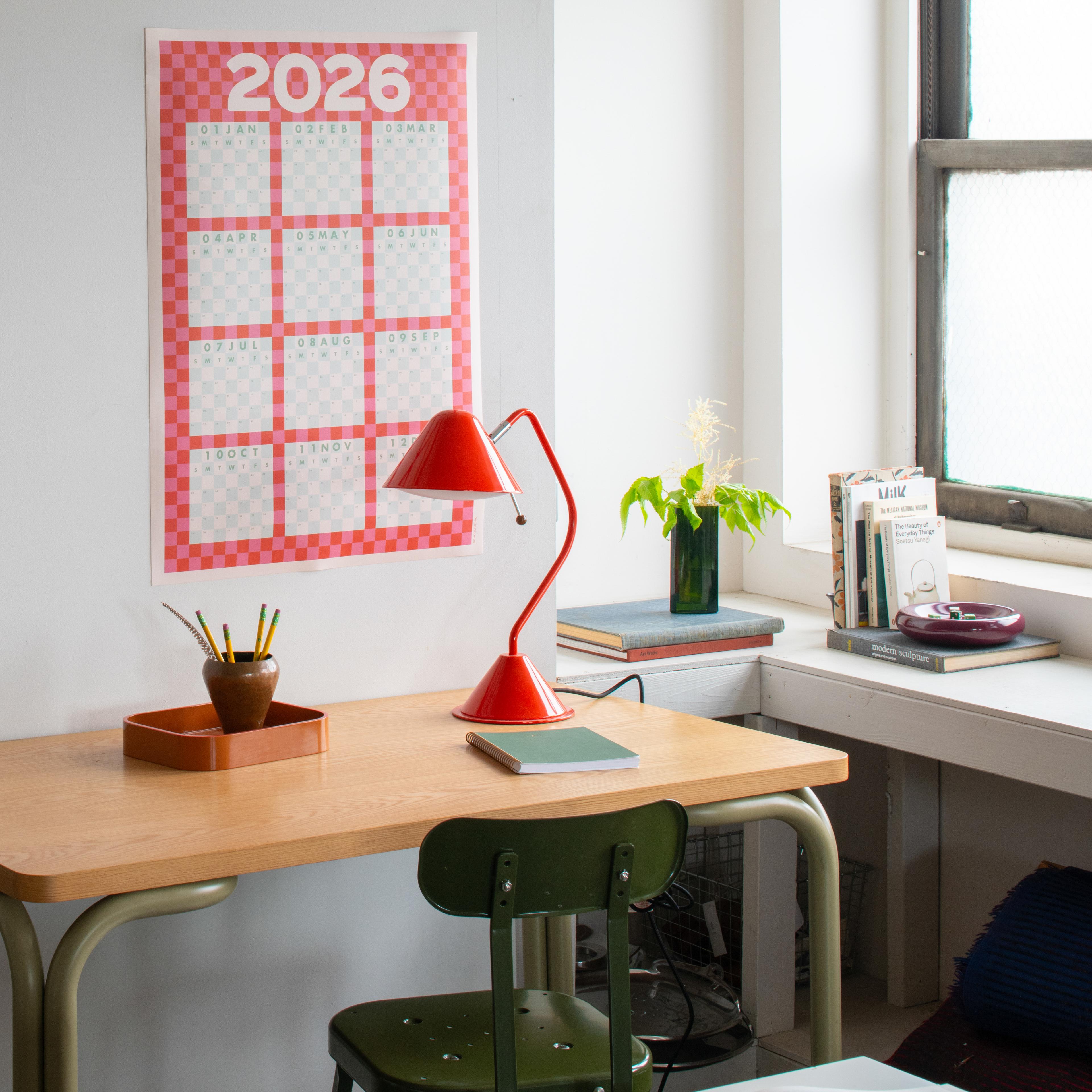 Calendar over desk area. 