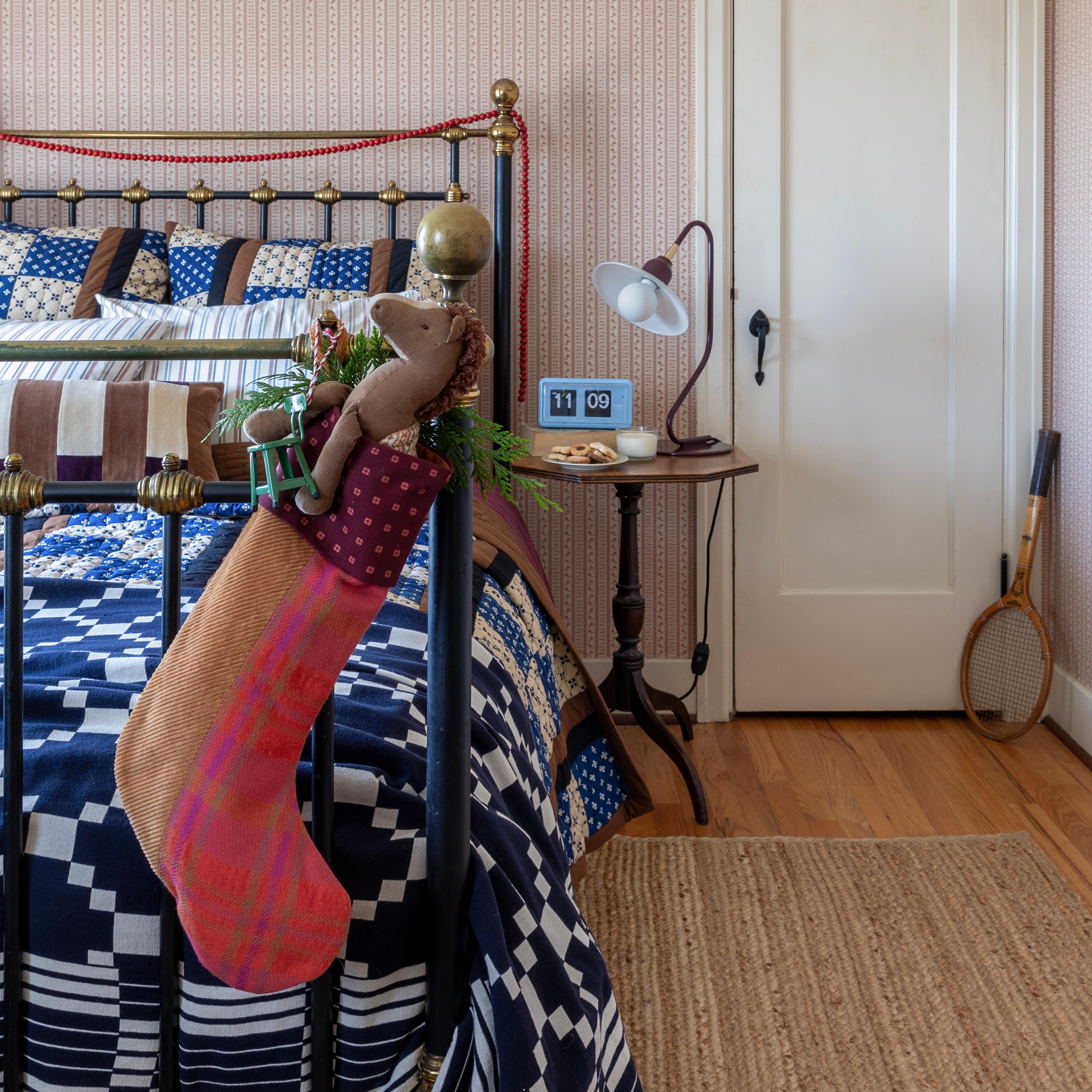 Stocking hanging on end of bed post. 