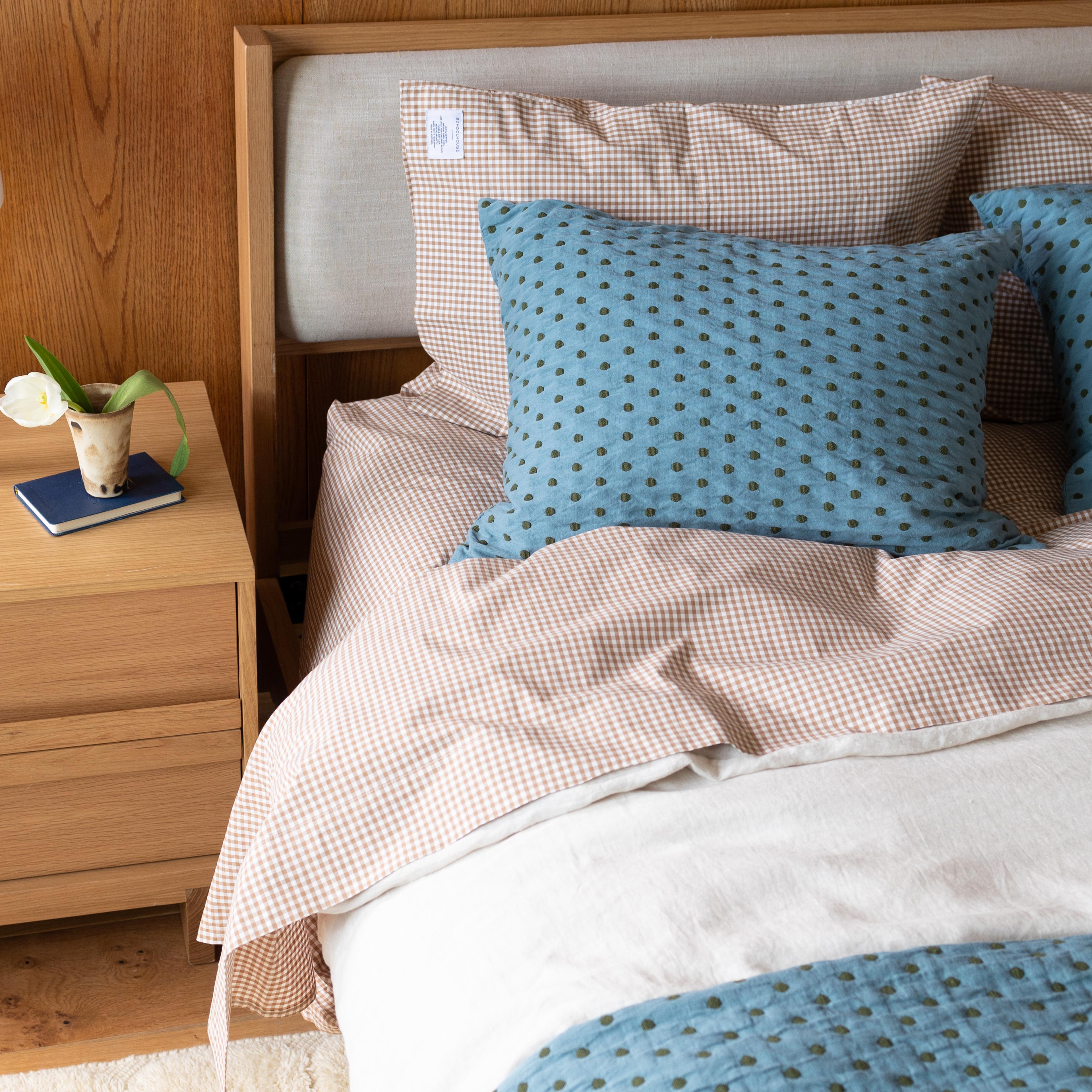 Blue polka dot sheets and gingham pillowcase 