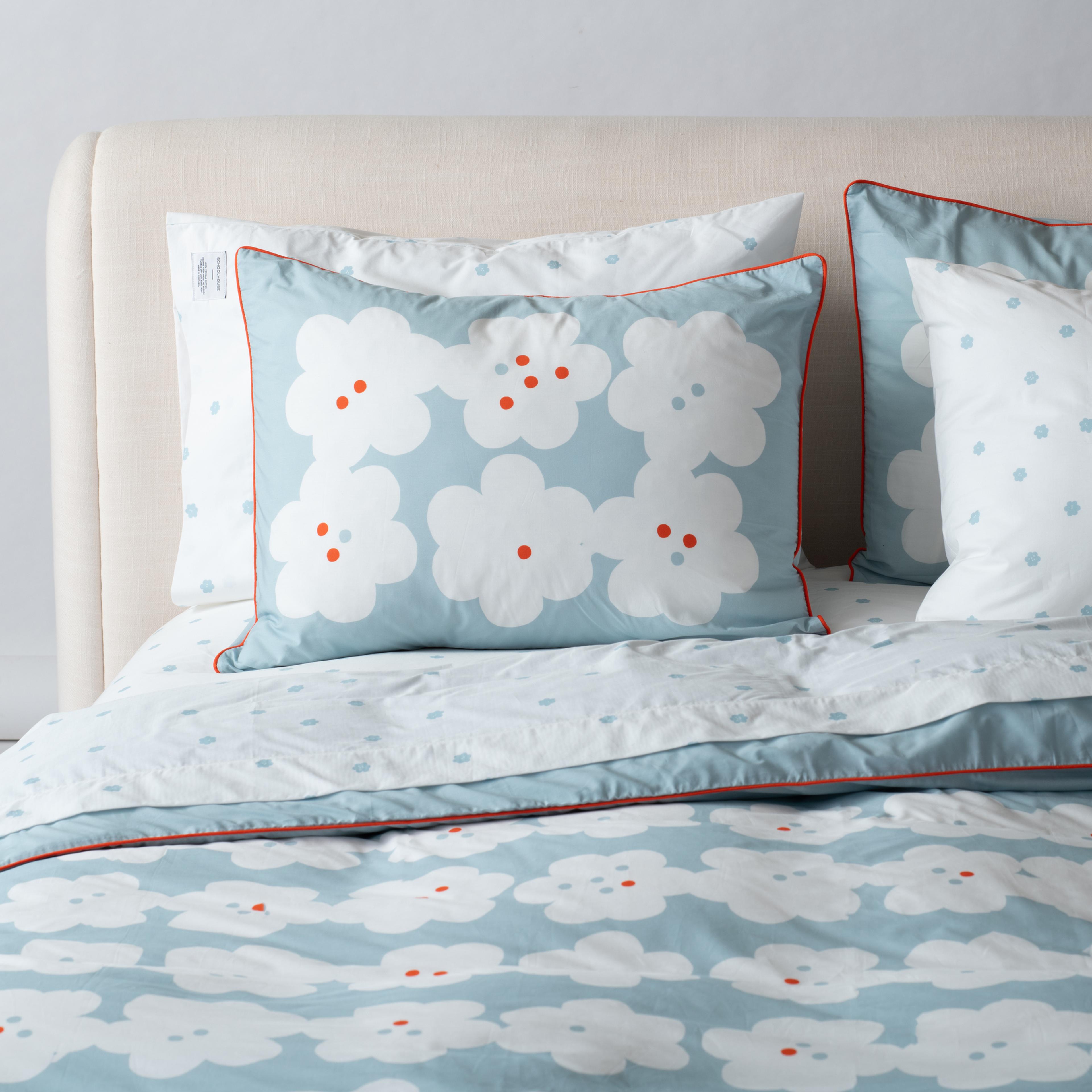 Light blue bedding with white flowers 