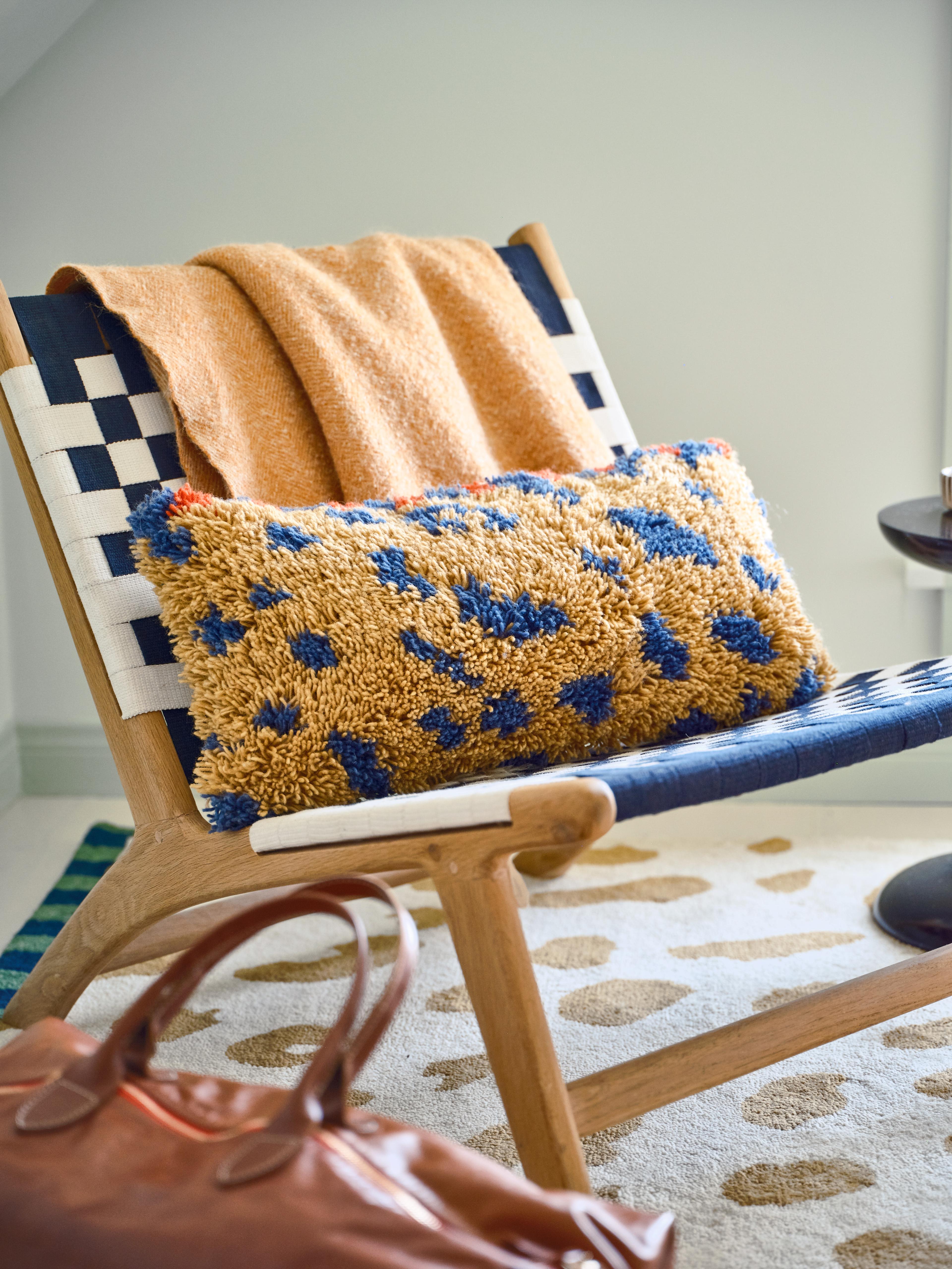 Detail shot of shag pillow on wooden chair 