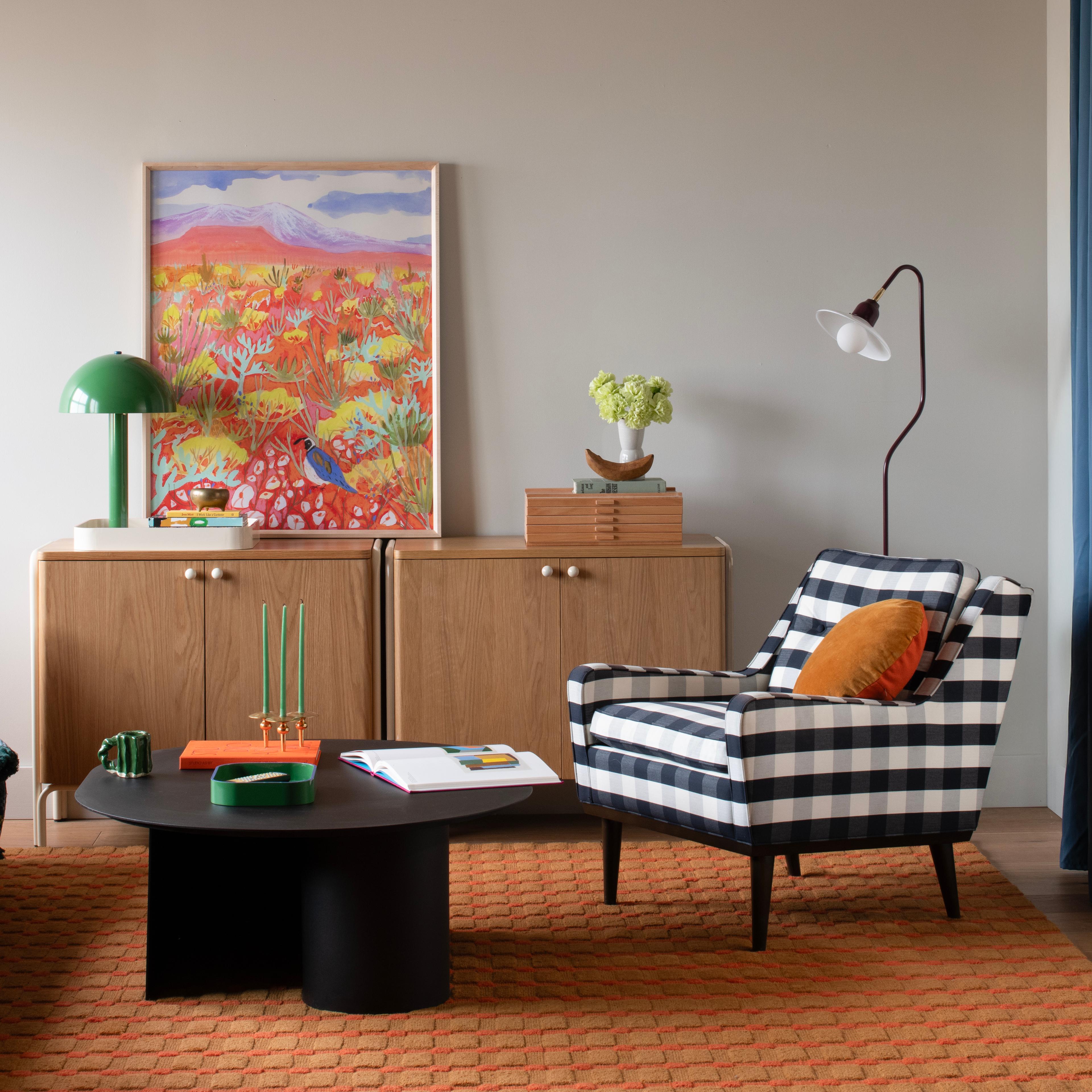 Bright living room with plaid chair and colorful accents 